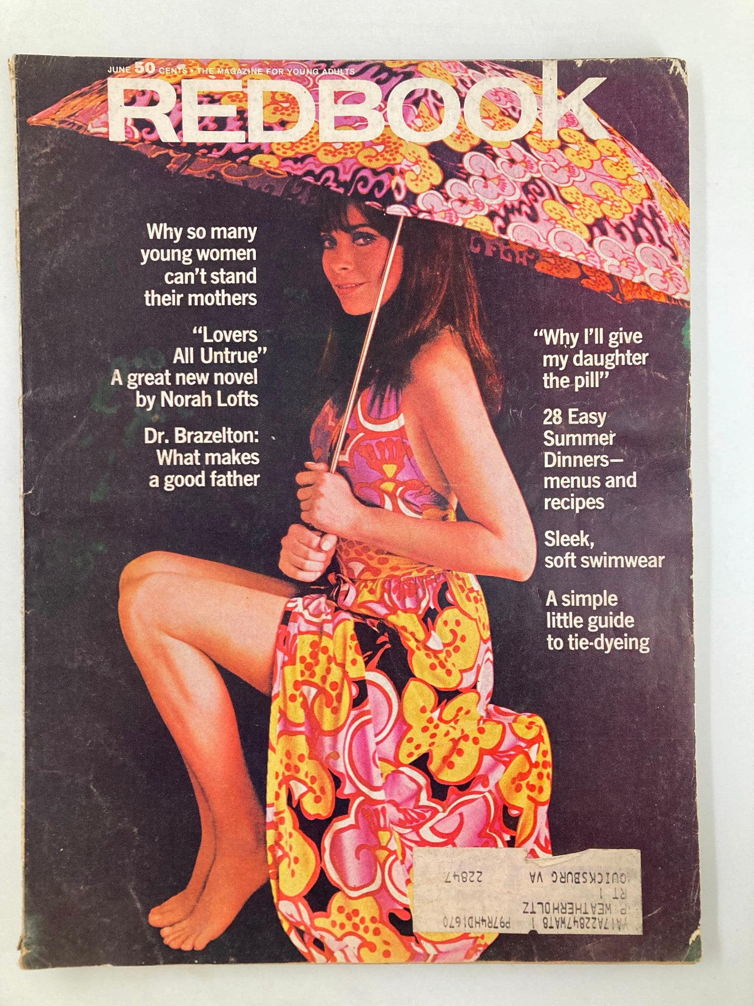 VTG Redbook Magazine June 1970 cover featuring a young woman with a colorful umbrella, showcasing a vibrant floral dress. The cover includes headlines discussing topics like relationships, summer dinners, and parenting advice.