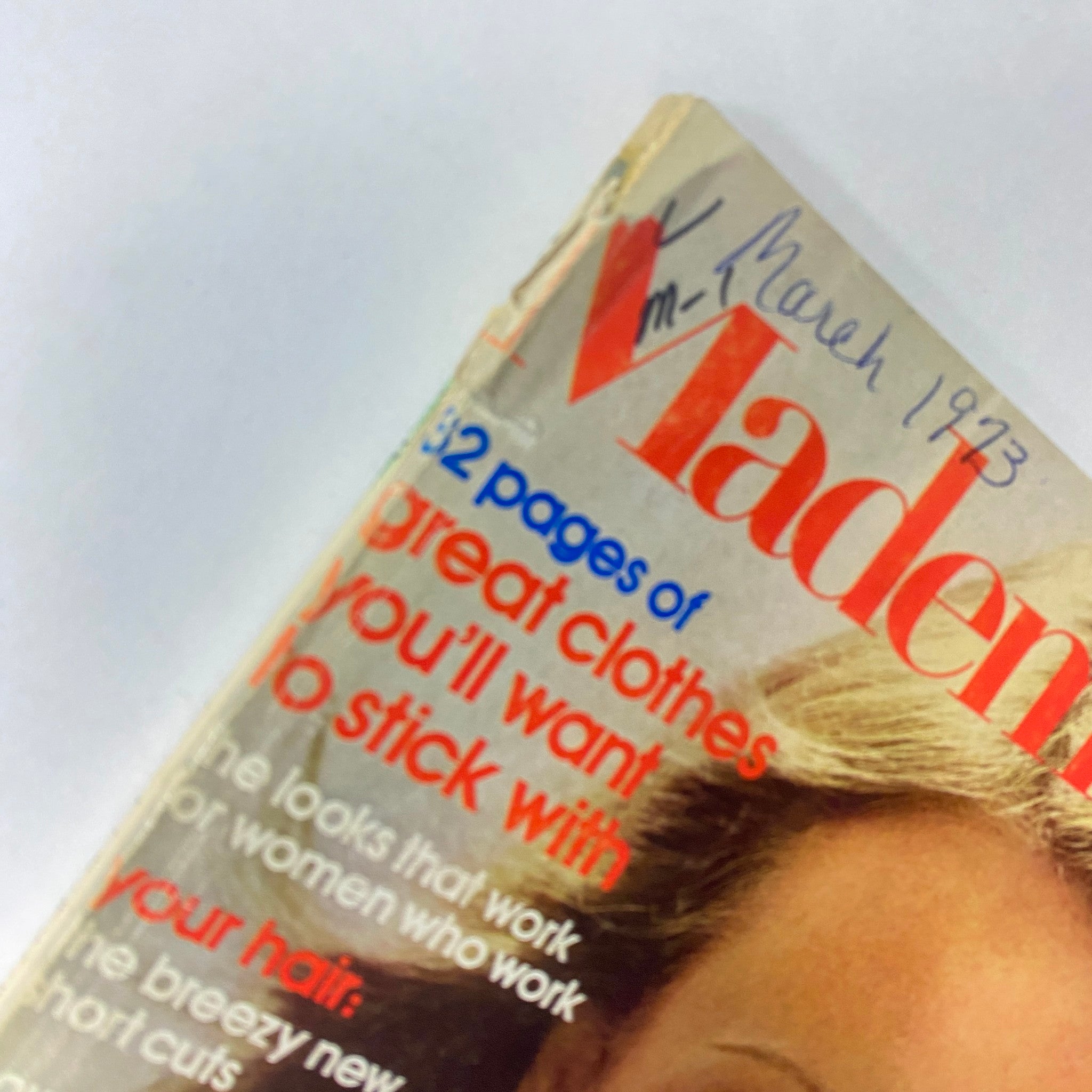 Close-up of Mademoiselle Magazine cover, March 1973, highlighting the title 'Woman Loves Work' by Amy Gross, featuring a young woman's face and vintage design elements.