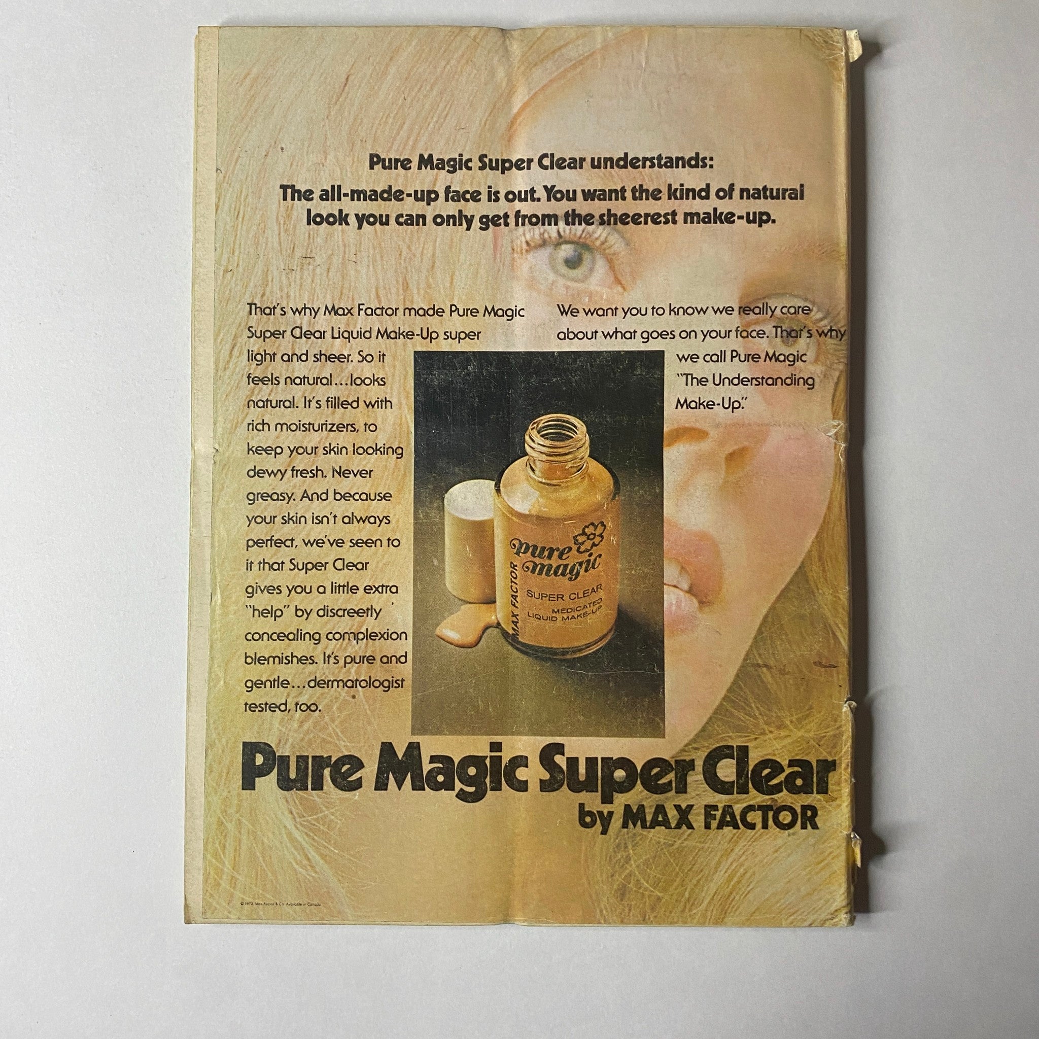 Mademoiselle Magazine April 1973 Three for the Bath: Peachy Clean with an advertisement for Pure Magic Super Clear by Max Factor, emphasizing a natural makeup look with a bottle and makeup suggestions.