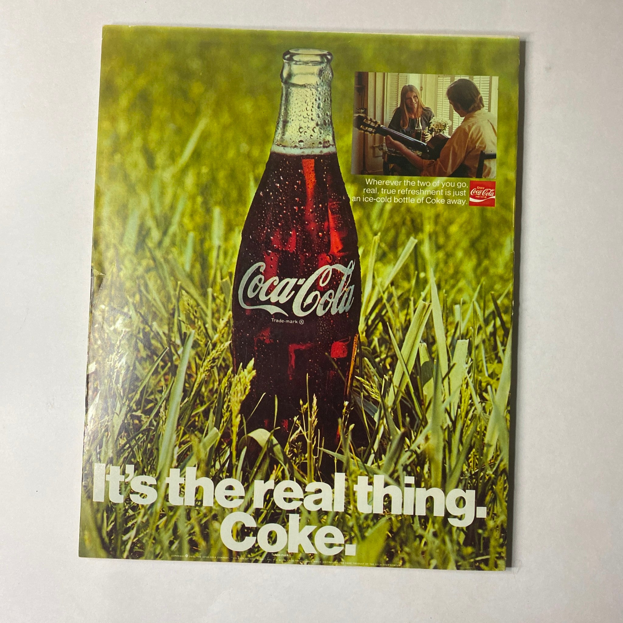 Back cover of Seventeen Magazine, October 1970 titled 'The Secret Wish of Unwed Fathers', featuring a Coca-Cola advertisement with a bottle of Coke set against a green grass background.