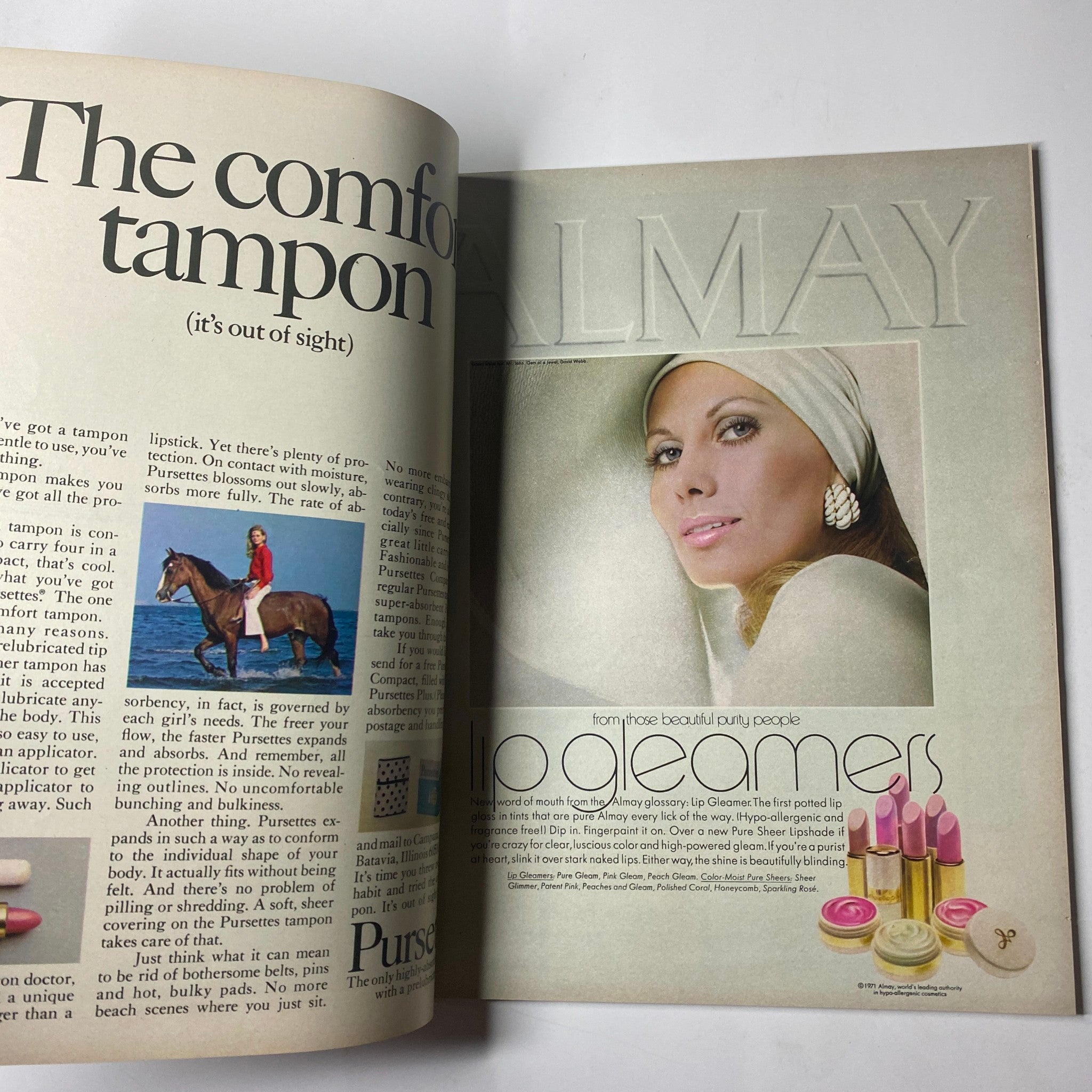 Advertisement for Almay cosmetics in Seventeen Magazine, February 1971, showcasing makeup products with a model demonstrating beauty trends of the era.