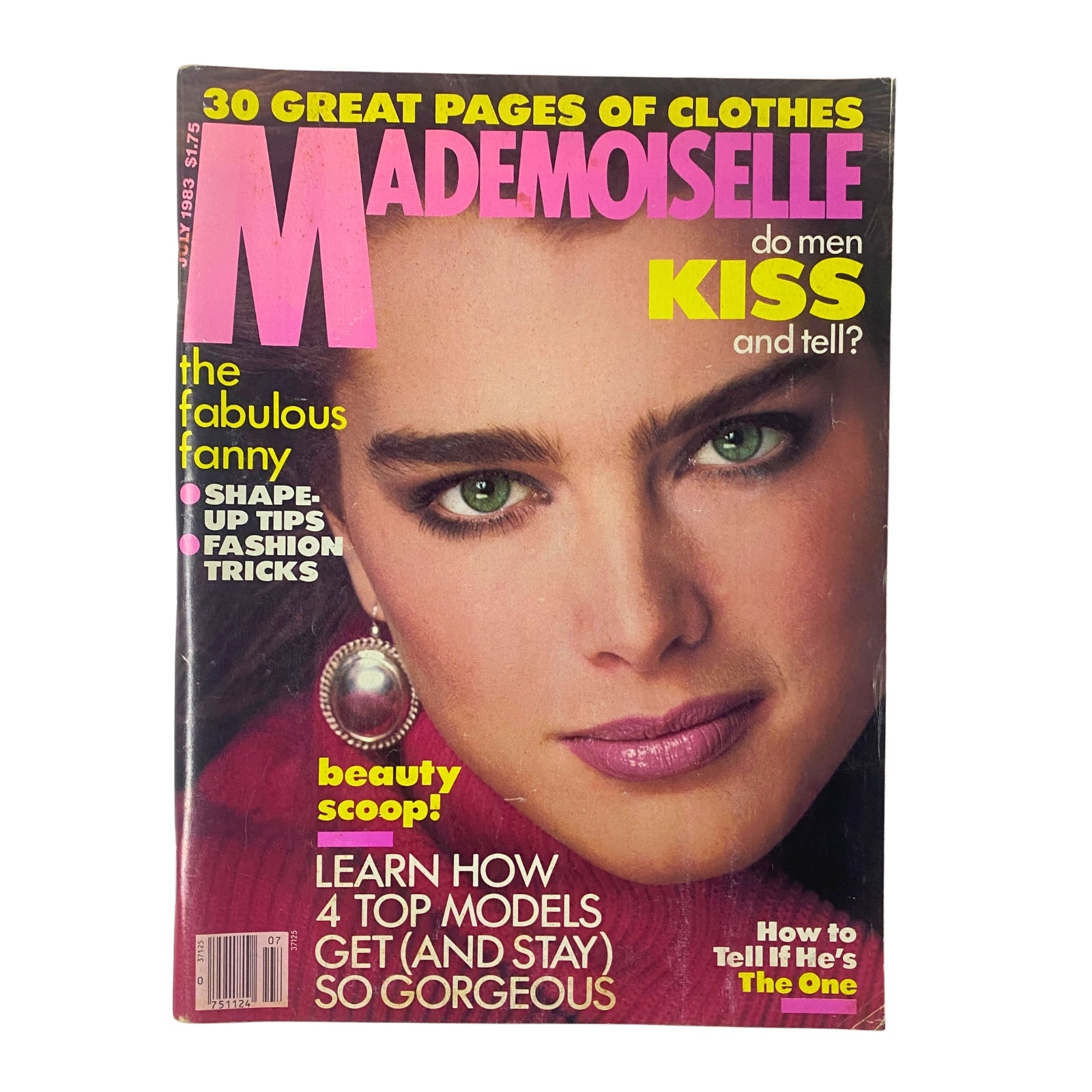 Mademoiselle Magazine July 1983 cover featuring model Brooke Shields with striking green eyes, promoting articles on fashion and beauty, highlighting topics like summer skincare and style tips.