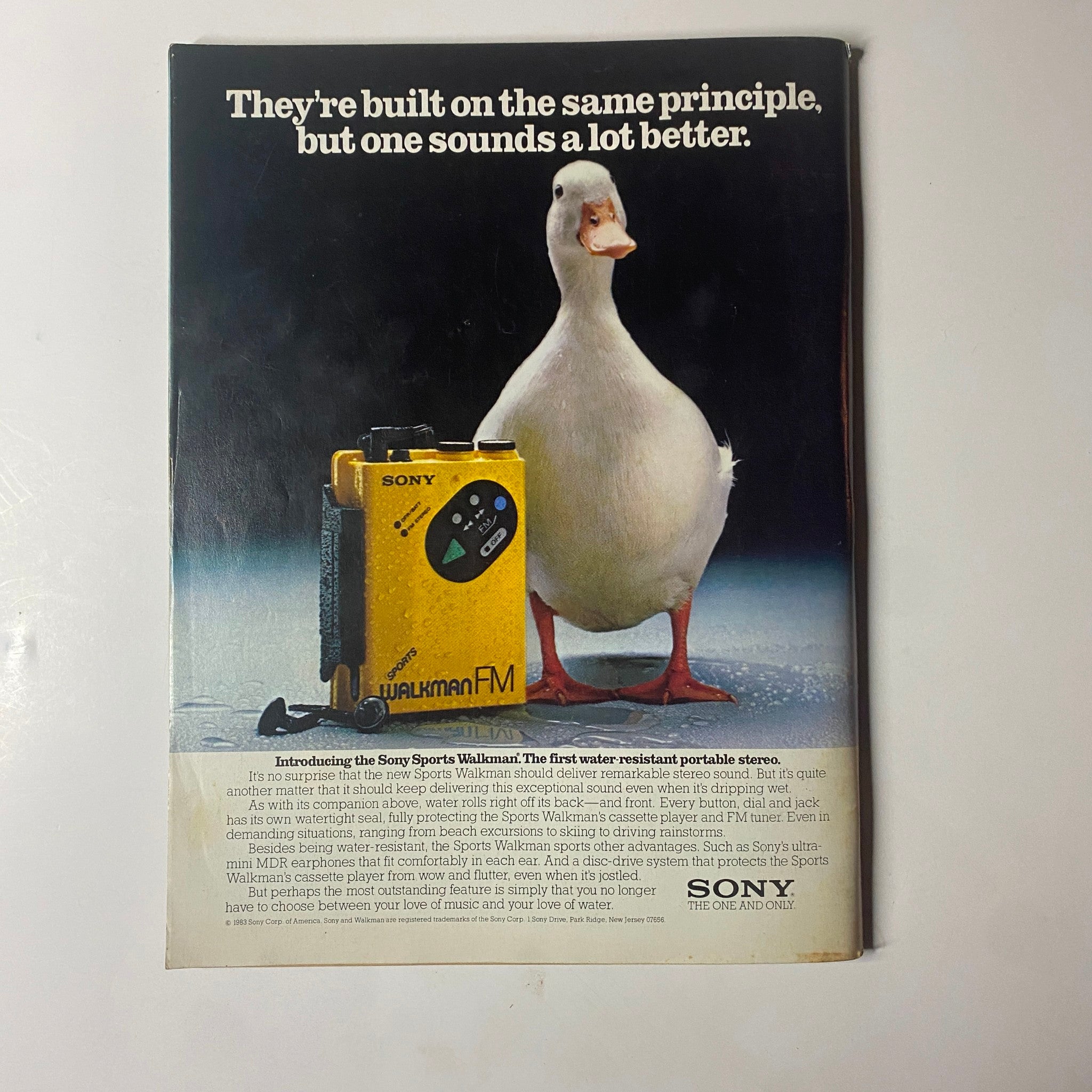 Vintage advertisement featuring a yellow Sony Sports Walkman and a duck, titled 'They're built on the same principle, but one sounds a lot better.' from Mademoiselle Magazine July 1983 with Brooke Shields.