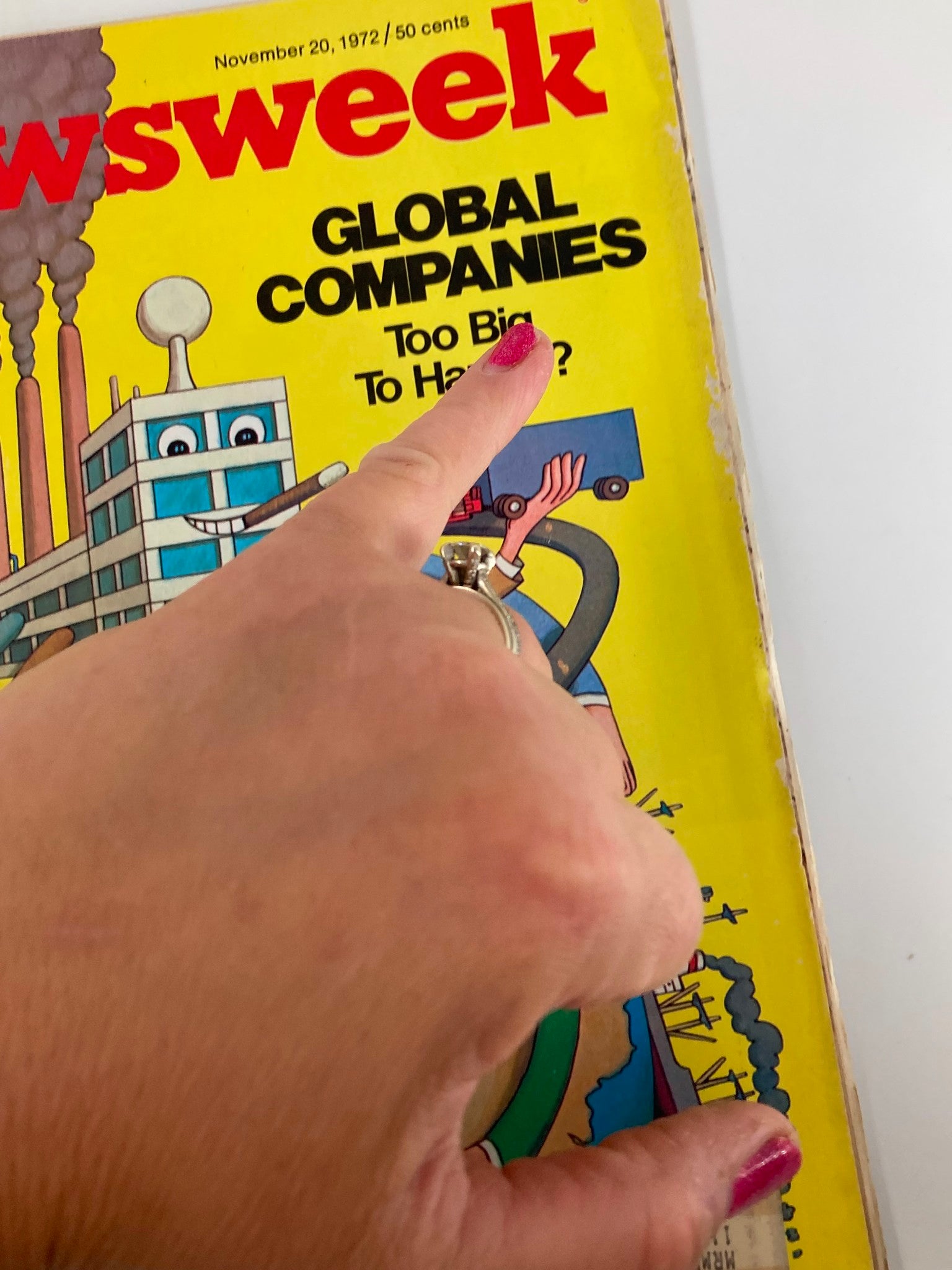 Close-up of the VTG Newsweek Magazine cover from November 20, 1972, featuring the title "Global Companies Too Big To Handle" with a hand pointing at the text, showcasing the vibrant yellow background and playful illustrations.