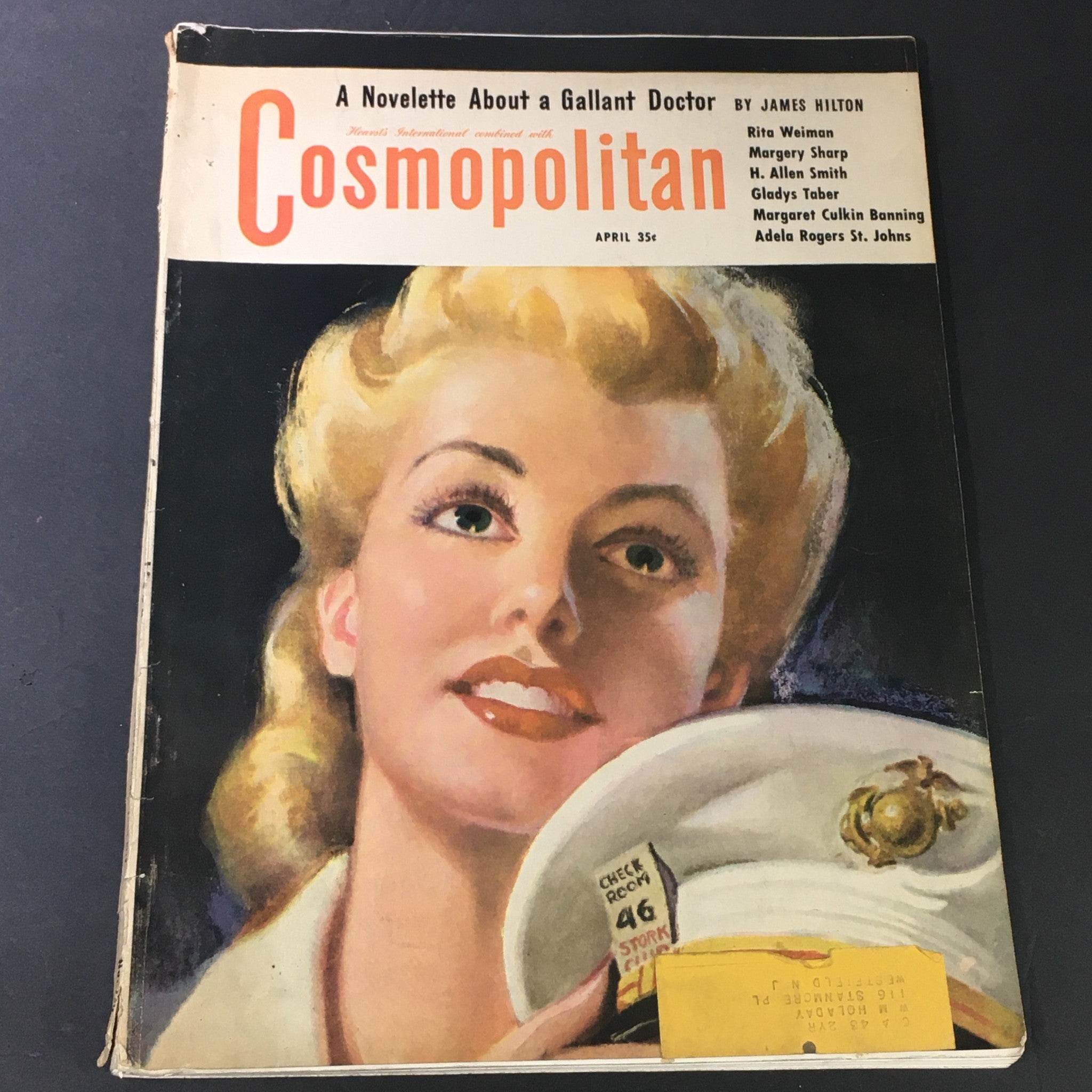 VTG Cosmopolitan Magazine April 1943 cover featuring an illustration of a smiling woman with blonde hair, showcasing the title prominently along with author names Rita Weiman, Margery Sharp, and Allen Smith.