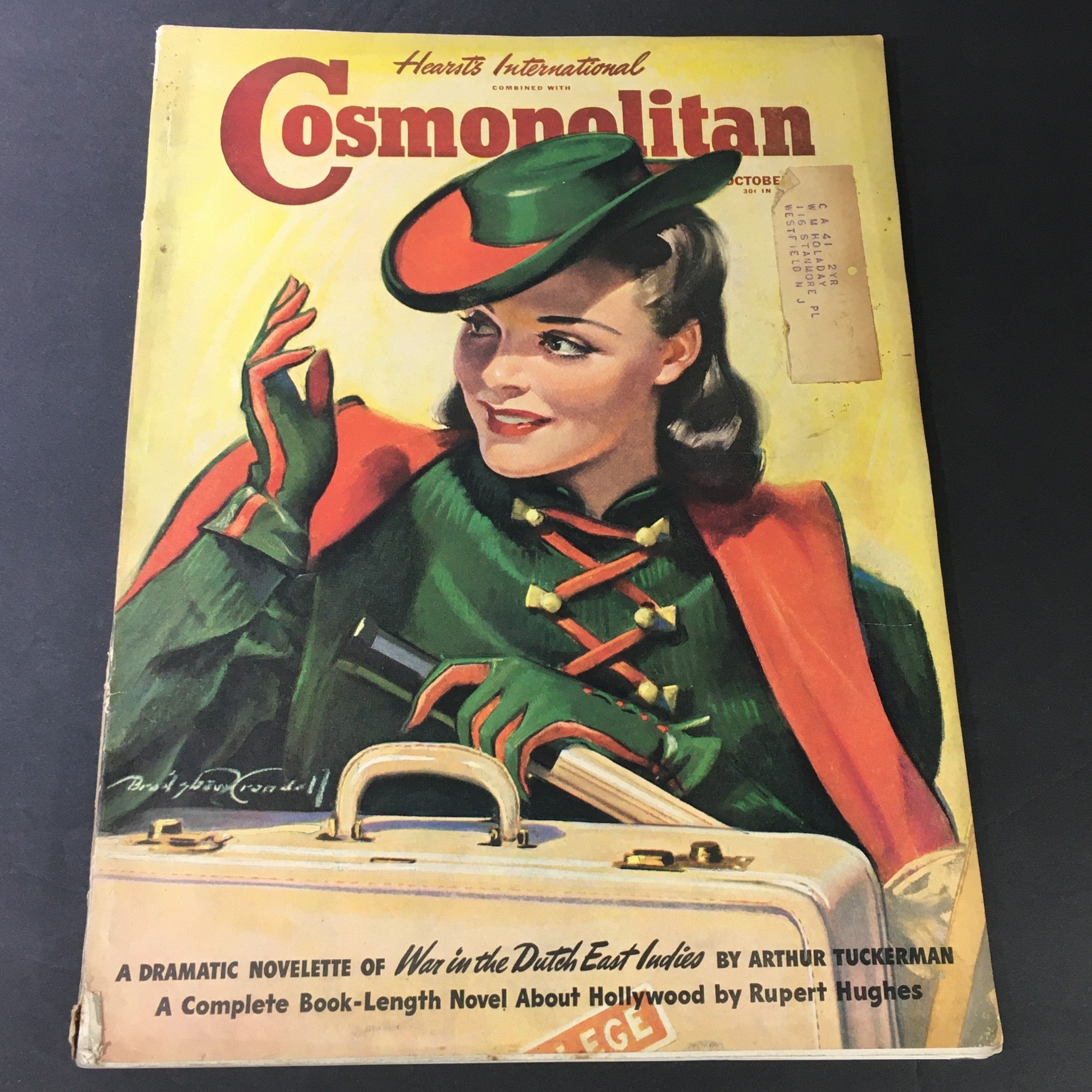 VTG Cosmopolitan Magazine #65 October 1940 cover featuring a beautiful woman in vintage fashion by Bradford Crandell with a suitcase.