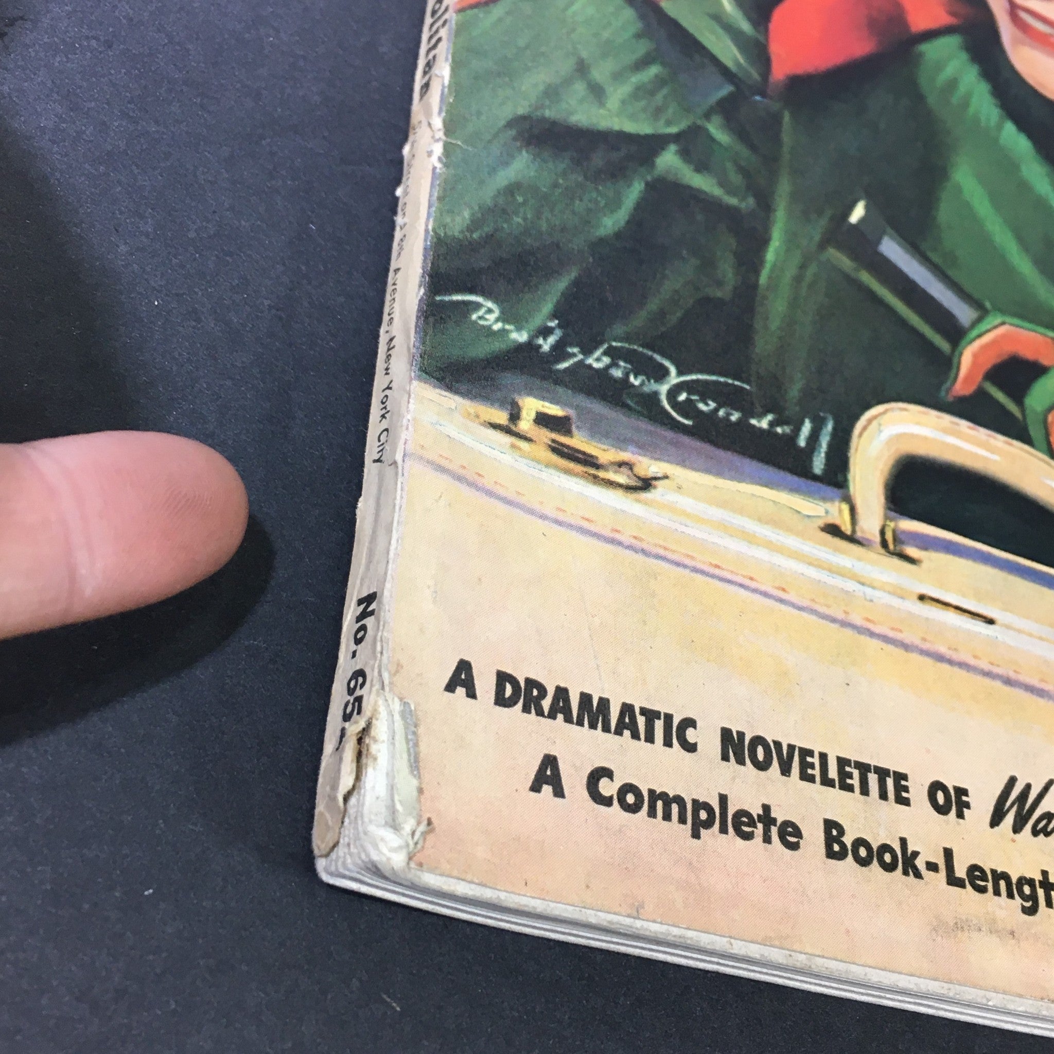 Detail of the spine of VTG Cosmopolitan Magazine #65 October 1940 showing wear and tear, emphasizing its vintage condition.