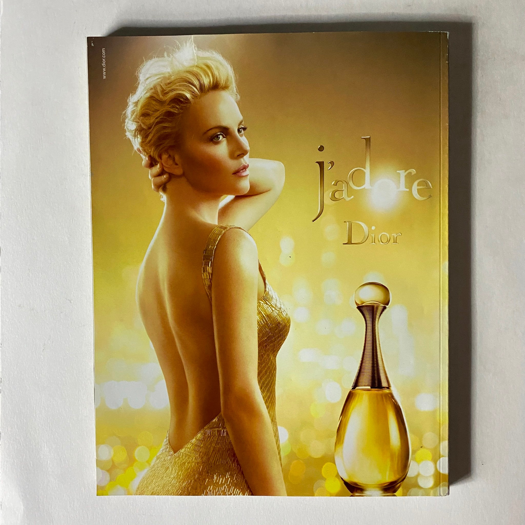 Advertisement for Dior's J'adore fragrance from Vogue Paris Magazine December 2014, featuring a glamorous model and luxurious branding.