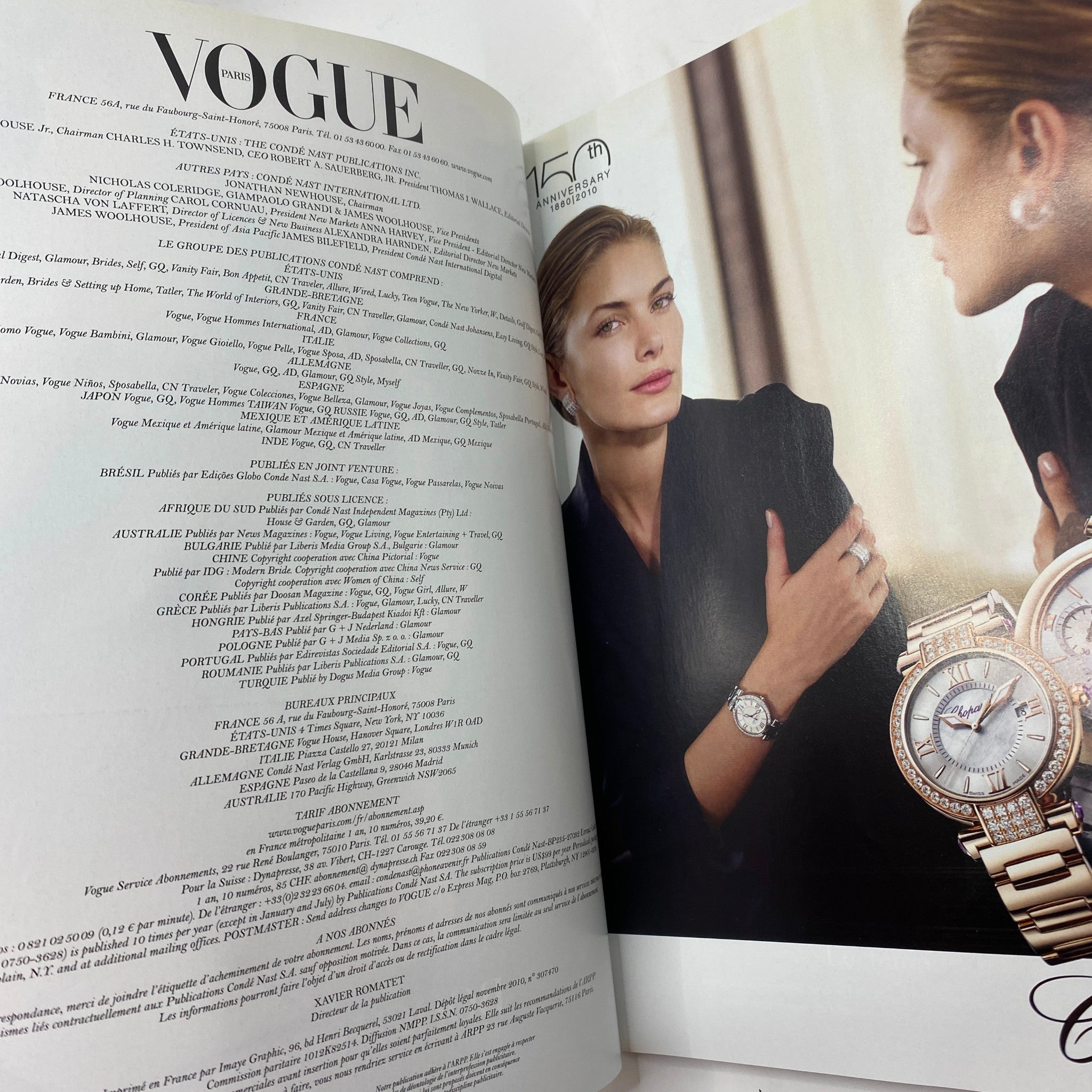 Inside page of Vogue Paris November 2010 magazine showcasing a model in a chic black outfit, as well as a luxury watch advertisement.