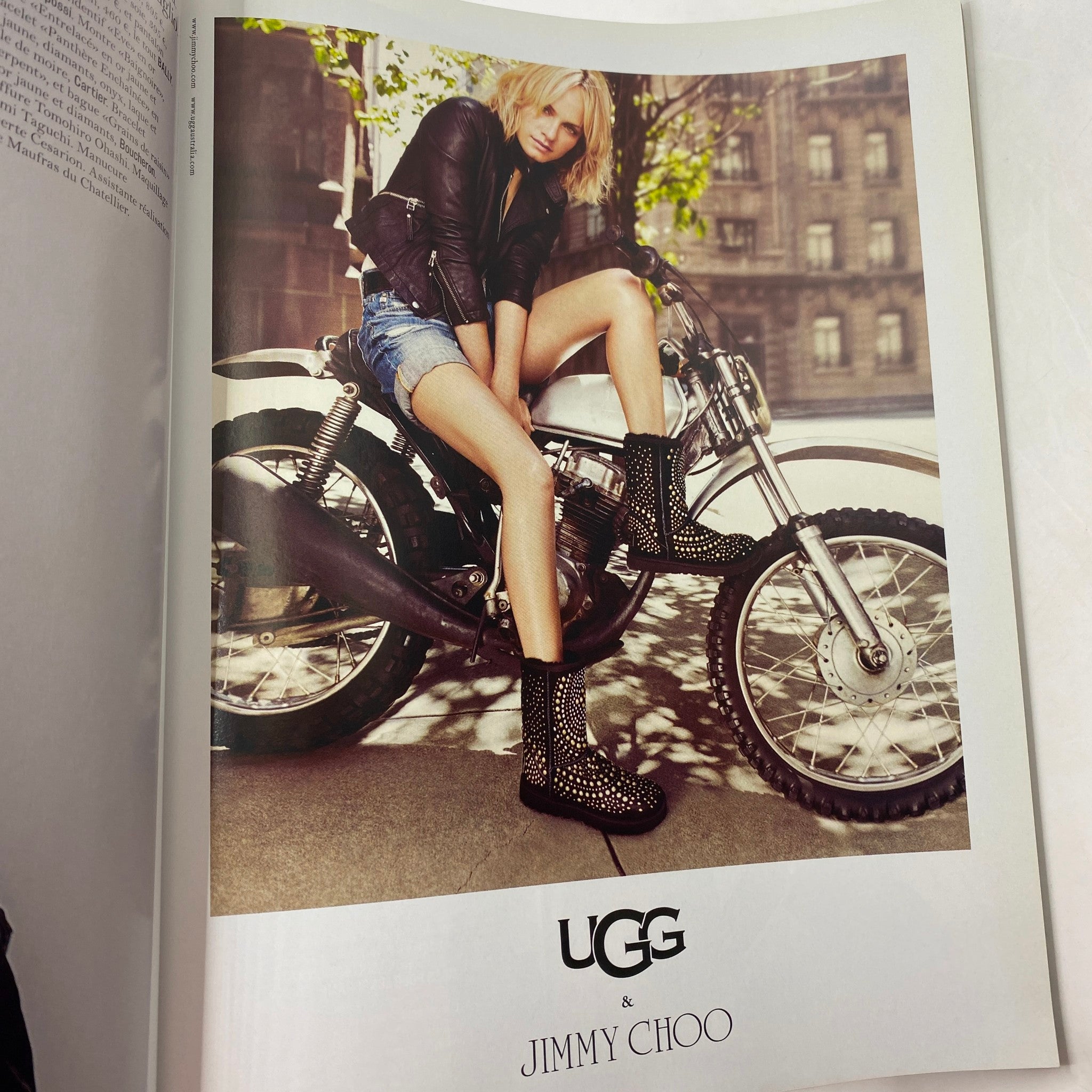 Page from Vogue Paris November 2010 magazine displaying an advertisement for UGG and Jimmy Choo with a stylish model on a motorcycle.