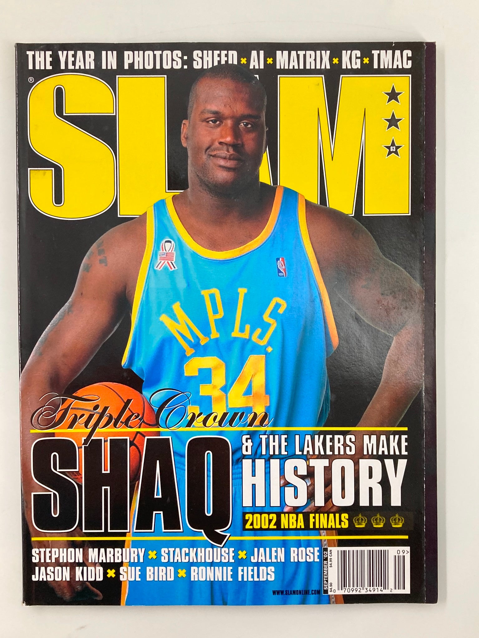 Cover of Slam Magazine September 2002 featuring NBA superstar Shaquille O'Neal in a blue jersey, highlighting his impact on the Los Angeles Lakers with the title 'Triple Crown Shaq & The Lakers Make History'.