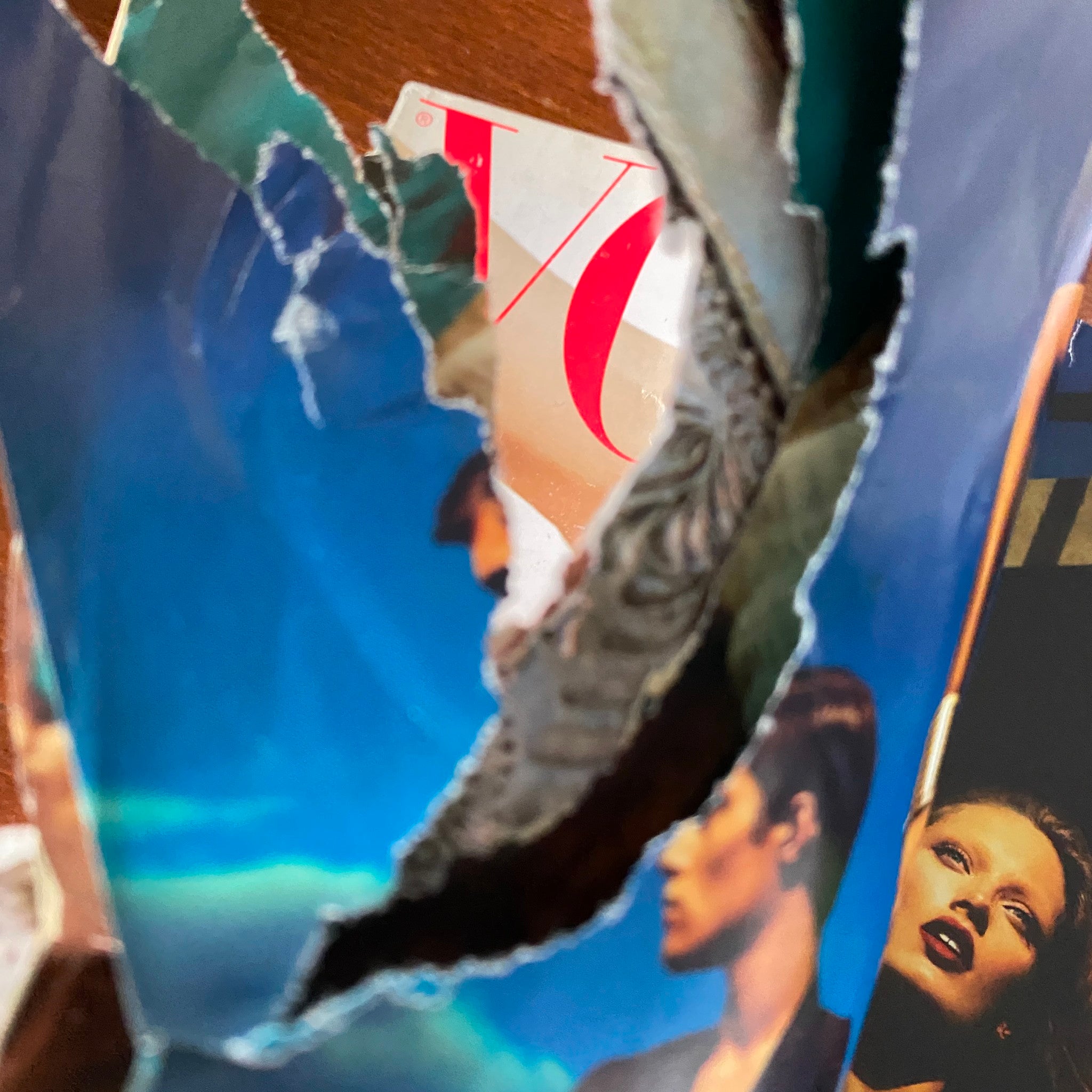 Close-up detail of a torn page from Vogue Magazine April 2011, showcasing its aged condition.