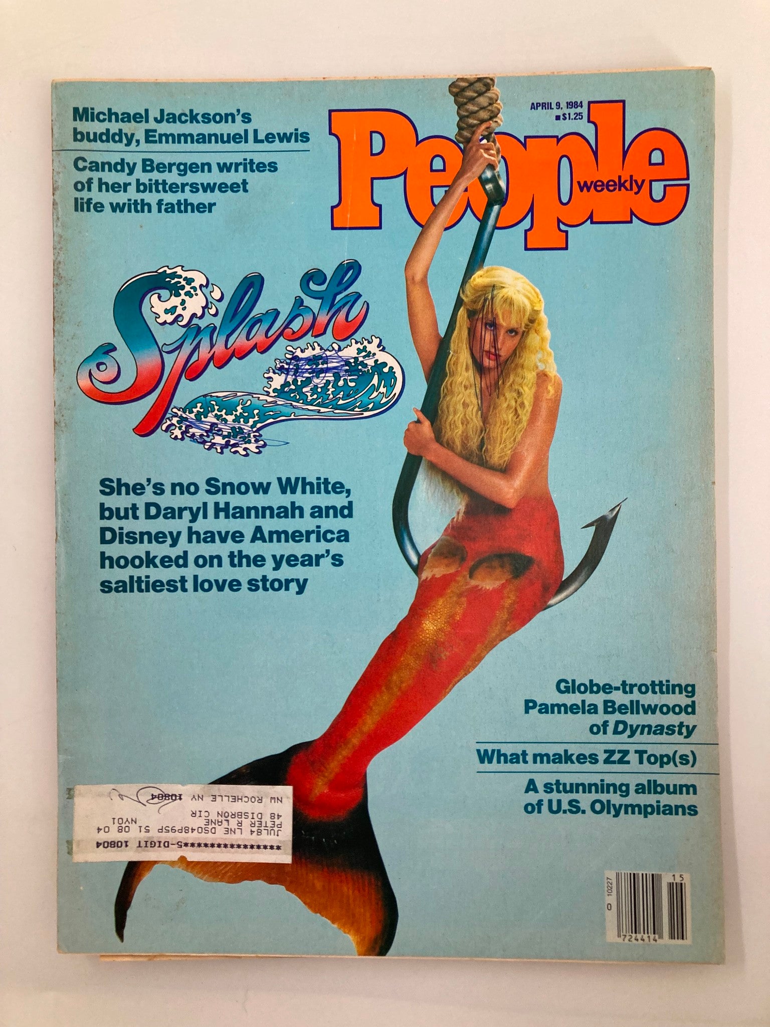 Cover of the April 9, 1984, People Weekly Magazine featuring Daryl Hannah and the Disney movie Splash, showcasing a vibrant blue background with colorful text. The cover highlights Daryl Hannah's iconic mermaid character, emphasizing her role in the film and its cultural significance.