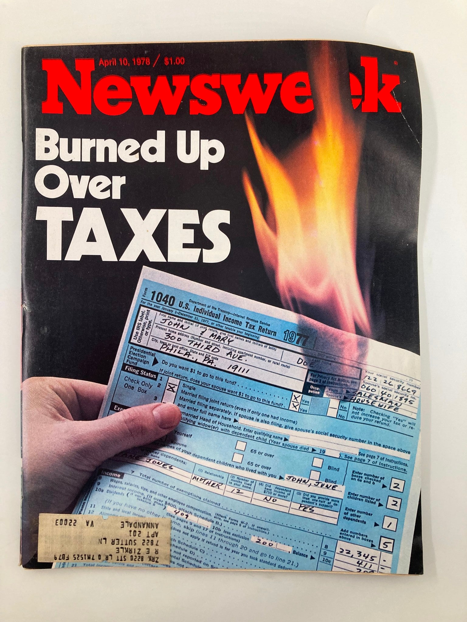 VTG Newsweek Magazine April 10 1978 cover featuring the title 'Burned Up Over Taxes' with an image of a hand holding a 1977 U.S. income tax return form, illustrating public sentiment toward taxes during the late 1970s.
