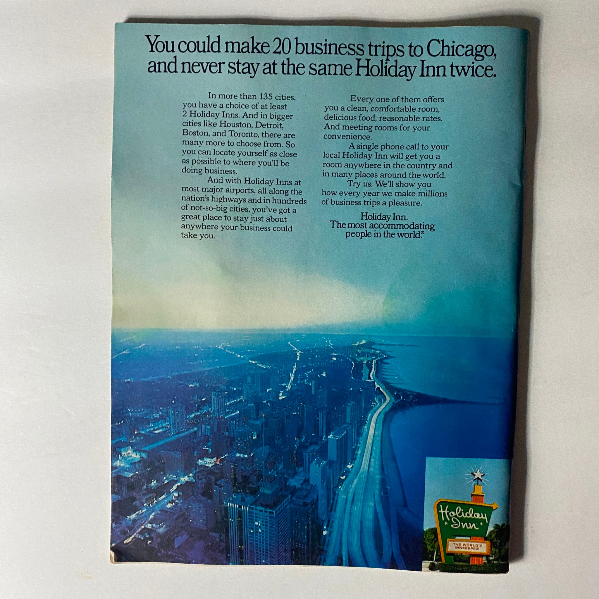 Vintage advertisement for Holiday Inn showcasing a skyline view, emphasizing the convenience of business travel options available across multiple cities.