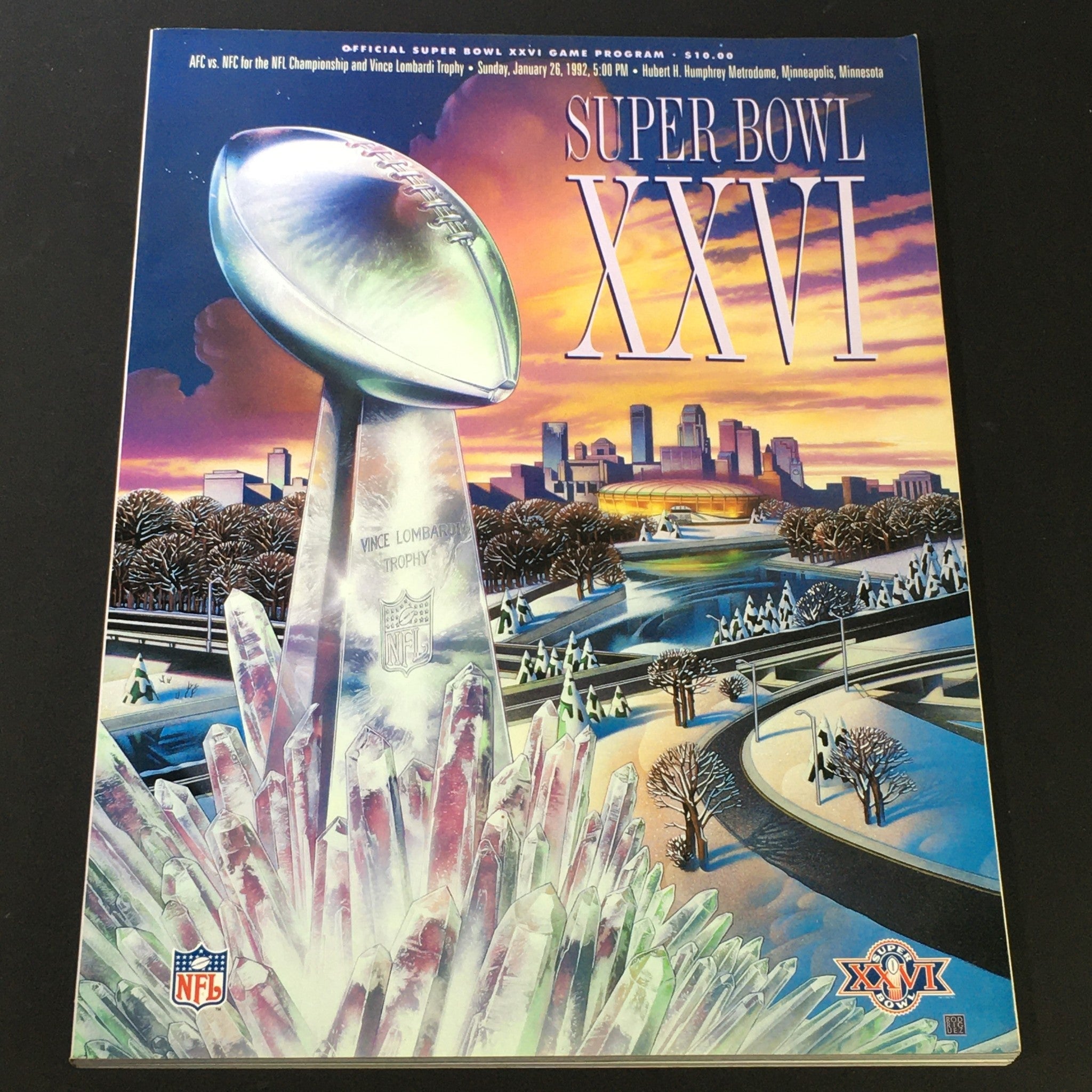 Cover of the VTG NFL Official Super Bowl XV Magazine from 1992, showcasing the Vince Lombardi Trophy against a colorful backdrop featuring a skyline, embodying the excitement of the NFL Championship.