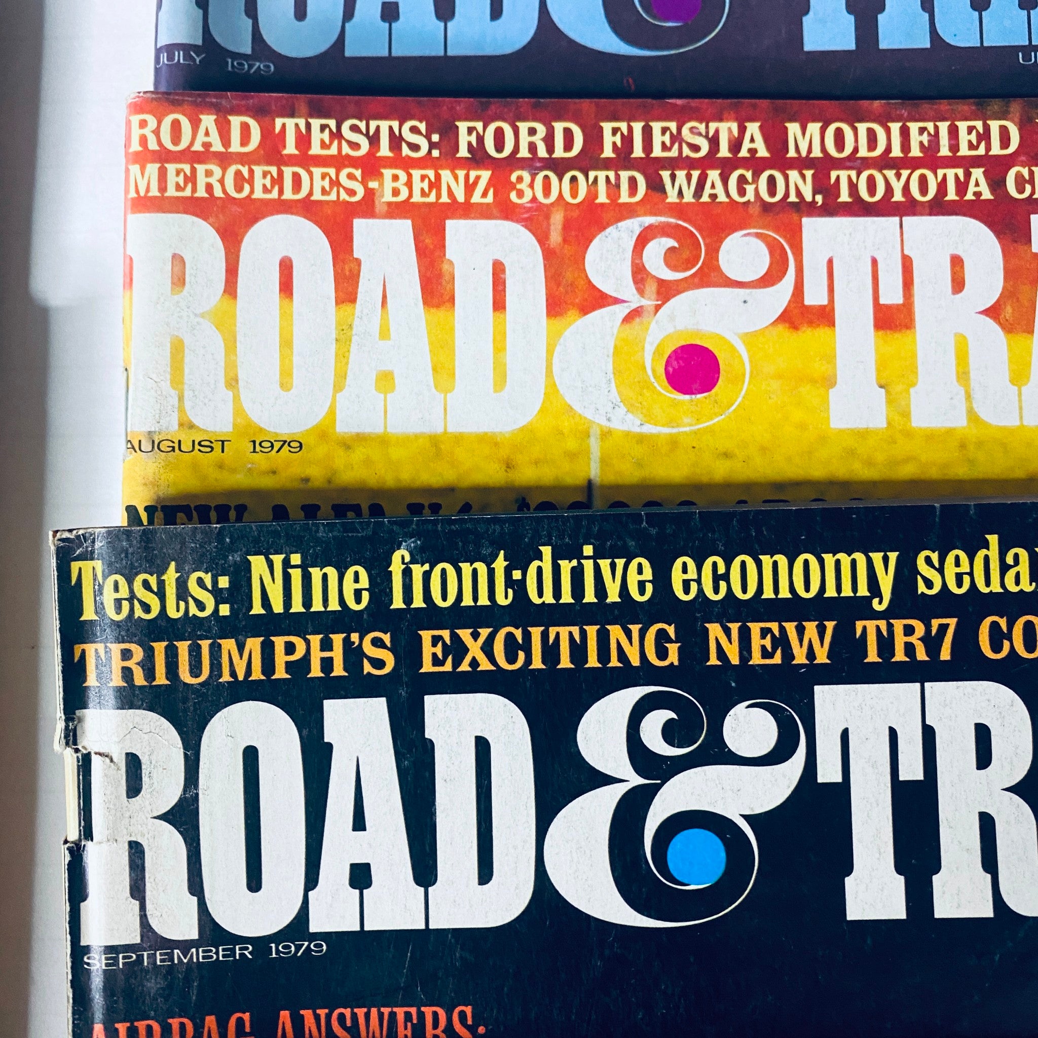 Covers of Road and Track Magazines July and August 1979, showcasing various car tests including the Ford Fiesta and Triumph TR7.