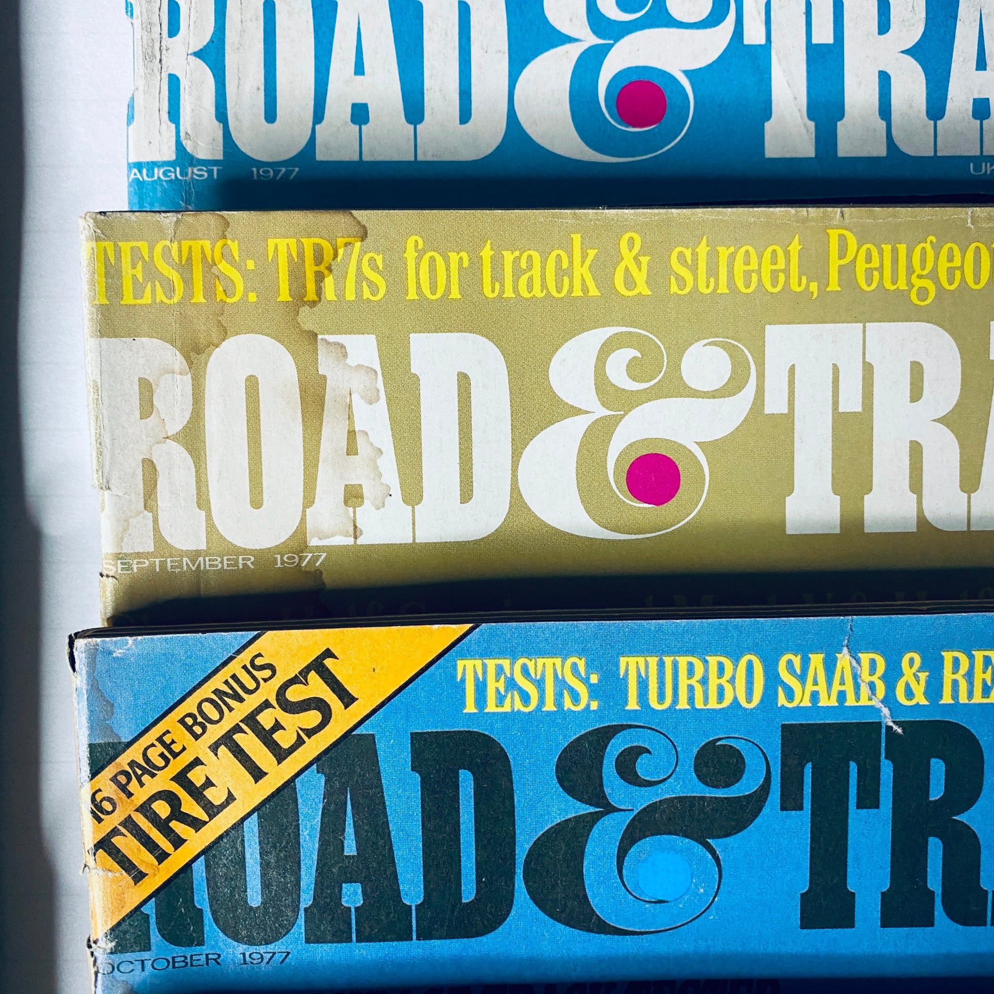 Lot of 10 Road & Track Magazine 1977 February, March, May, June, August-December displaying magazine covers from the August to October issues with automotive testing features.