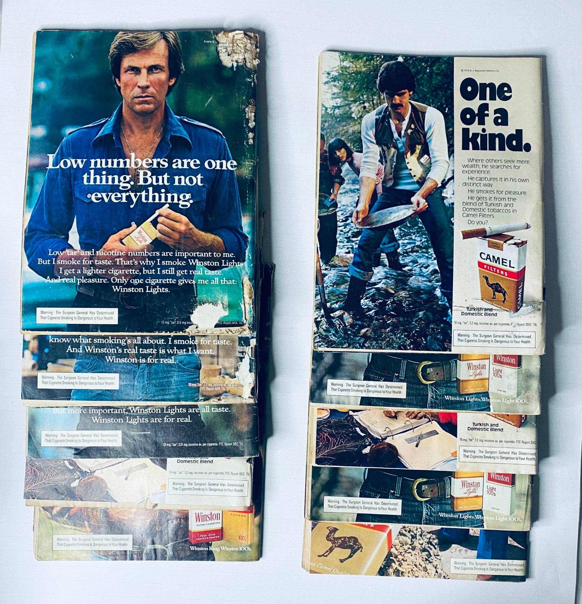 Side-by-side view of Road & Track Magazine covers, including a close-up of a man with a fishing rod, highlighting cigarettes and damaged edges. Title: Lot of 10 Road & Track Magazine 1977 February, March, May, June, August-December.