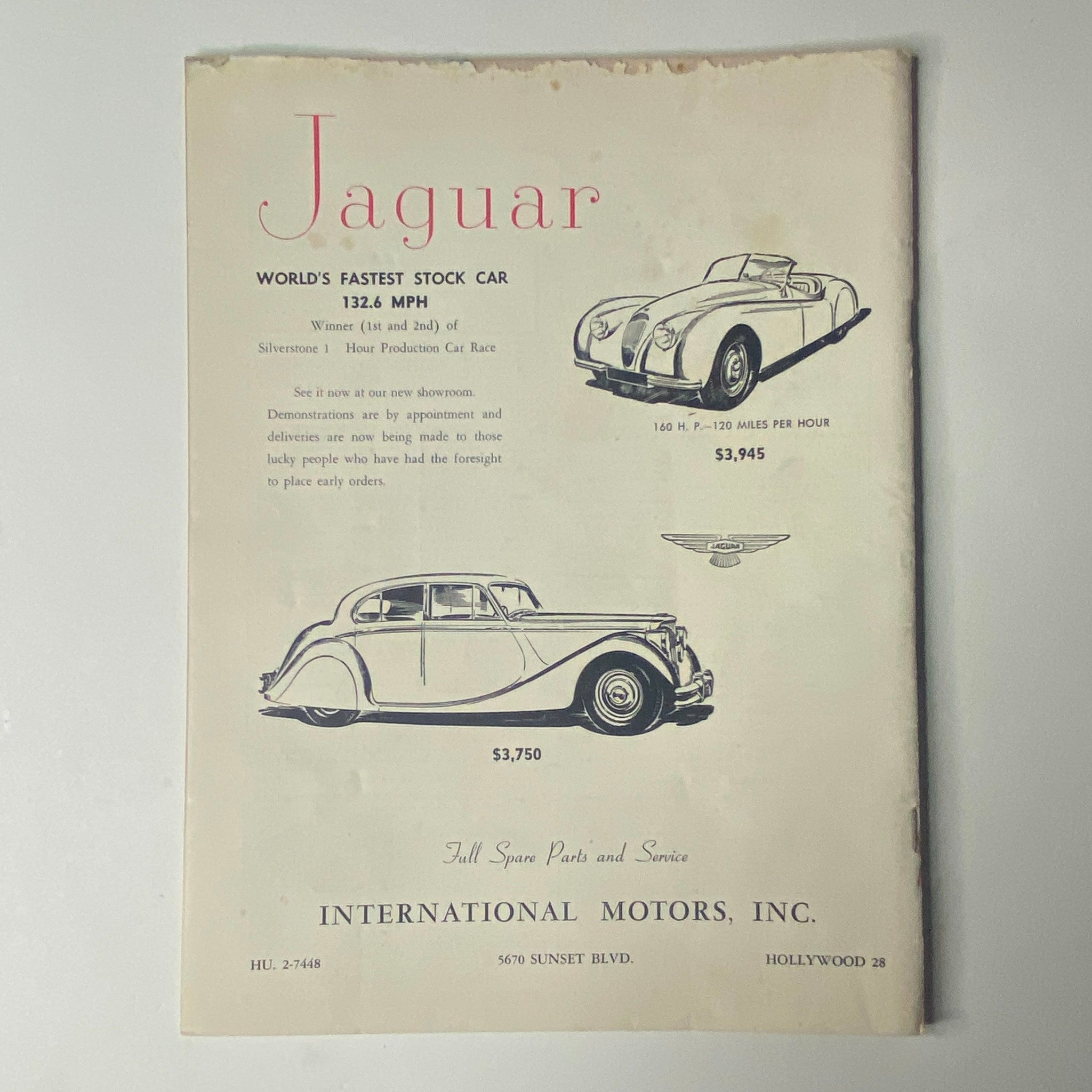 Road and Track Magazine December 1949 image displaying an advertisement for Jaguar, highlighting the world's fastest stock car with a price list and performance information.