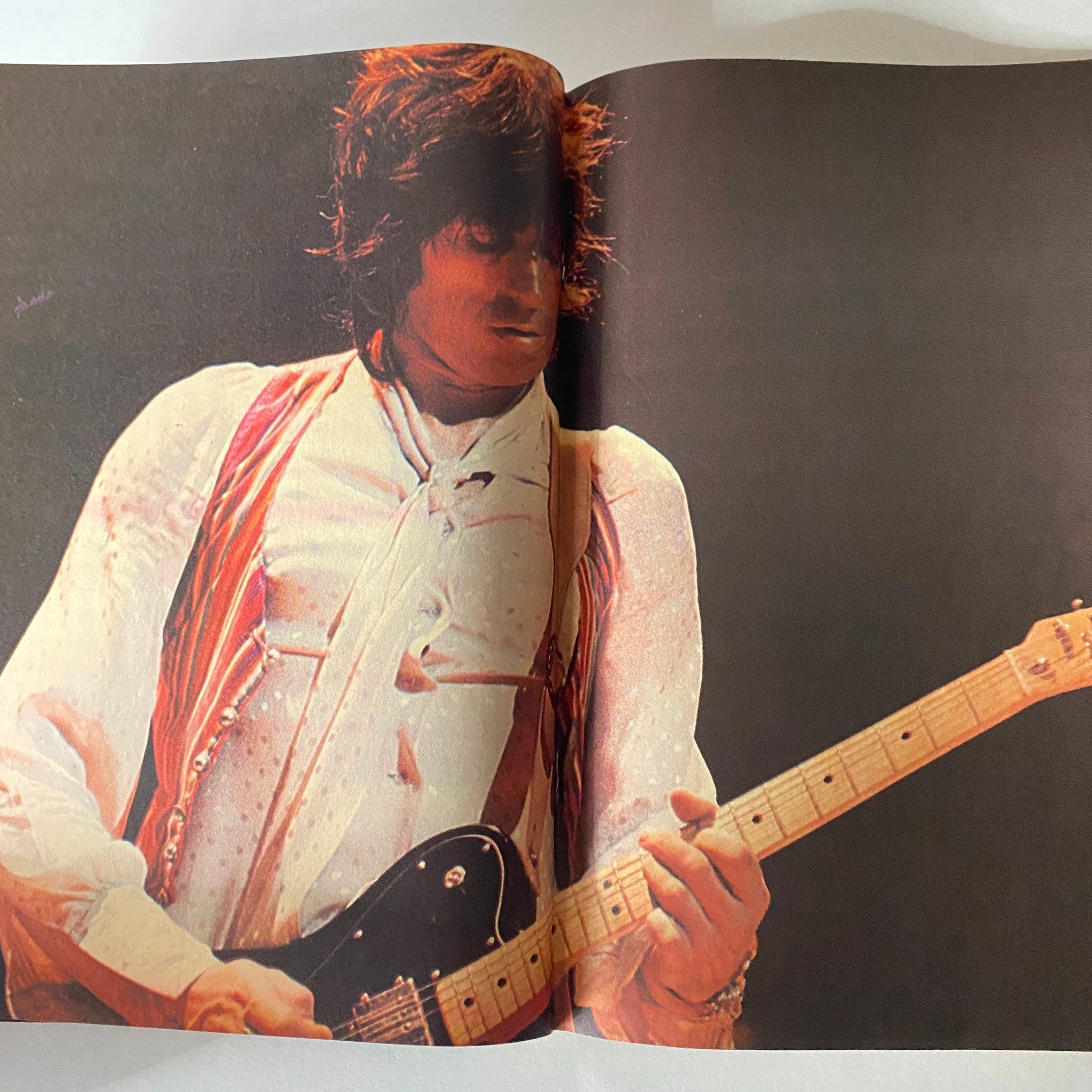 Photograph from Hit Parader Magazine January 1978, displaying a close-up of a musician playing guitar, capturing the vibrant performance energy.