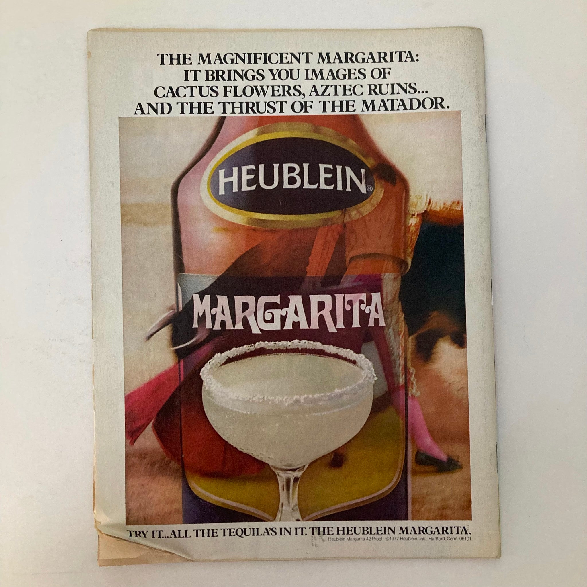 Cover of a vintage advertisement for Heublein Margarita with an image of a margarita and text describing its qualities.