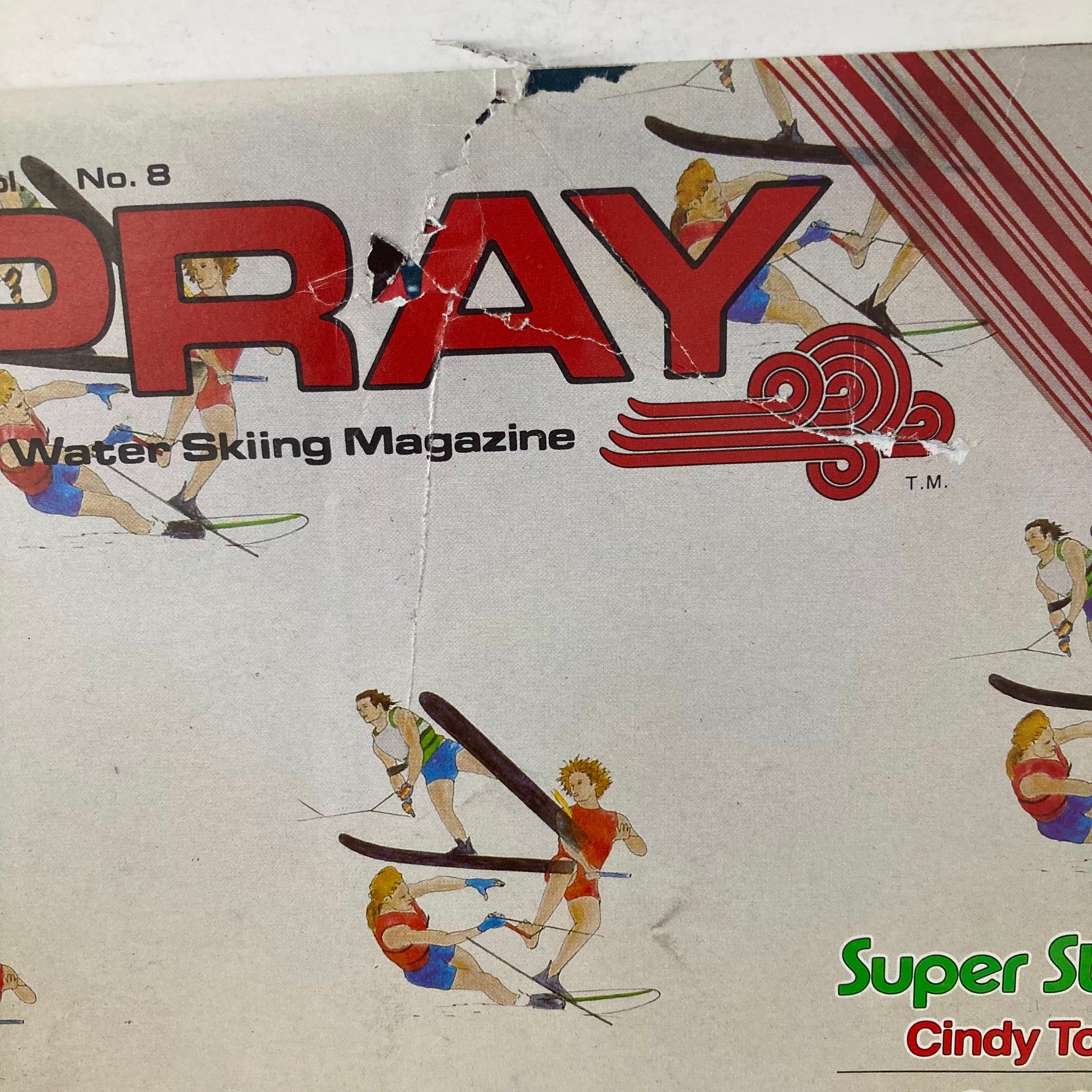 Close-up of the cover of Spray The Water Skiing Magazine Winter 1977, emphasizing the title and Super Star Cindy Todd. It displays detailed artwork of water skiing activities.