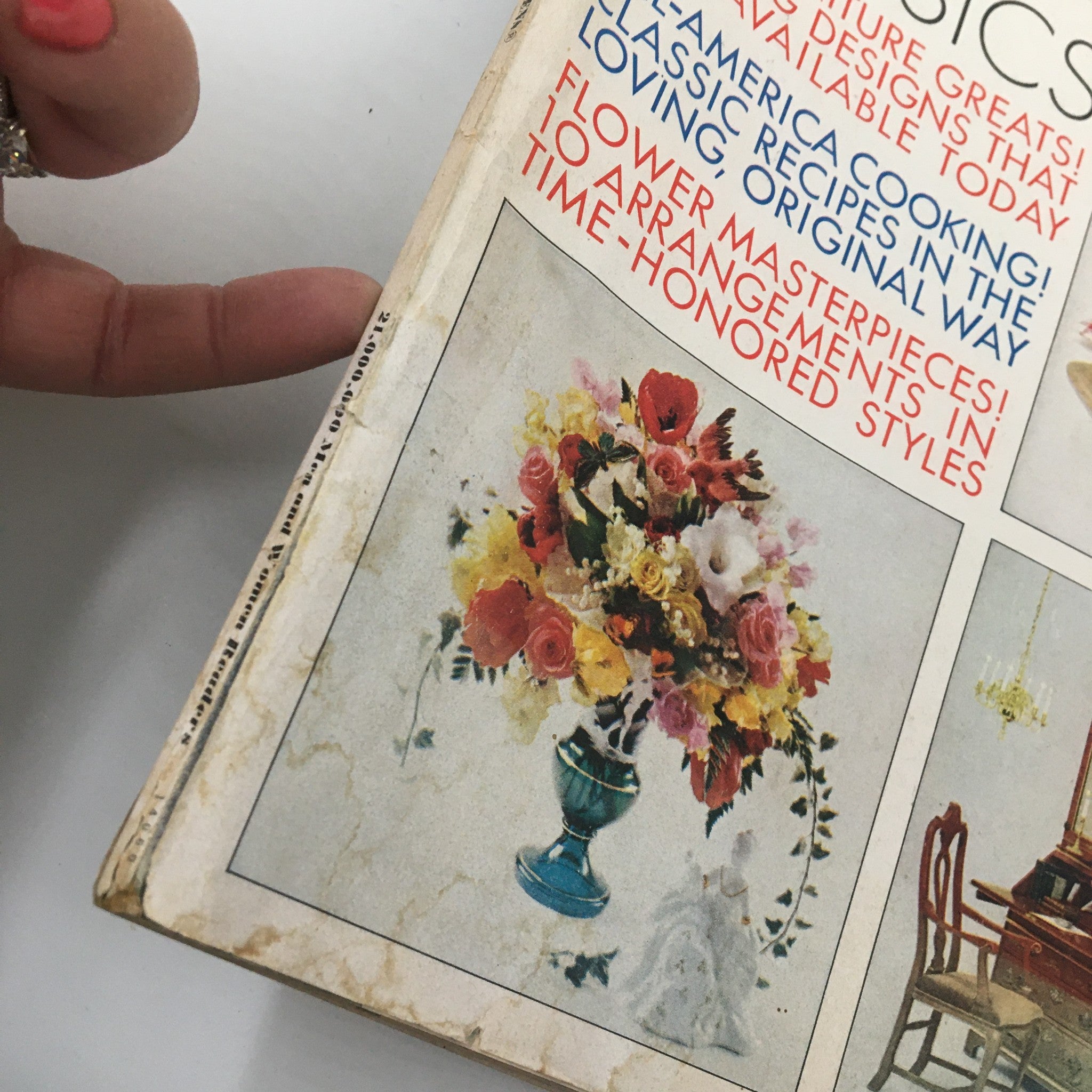 Close-up view of the side of the VTG Better Homes & Gardens Magazine October 1970 showing a colorful floral arrangement illustration and the magazine's title, emphasizing classic home decor.