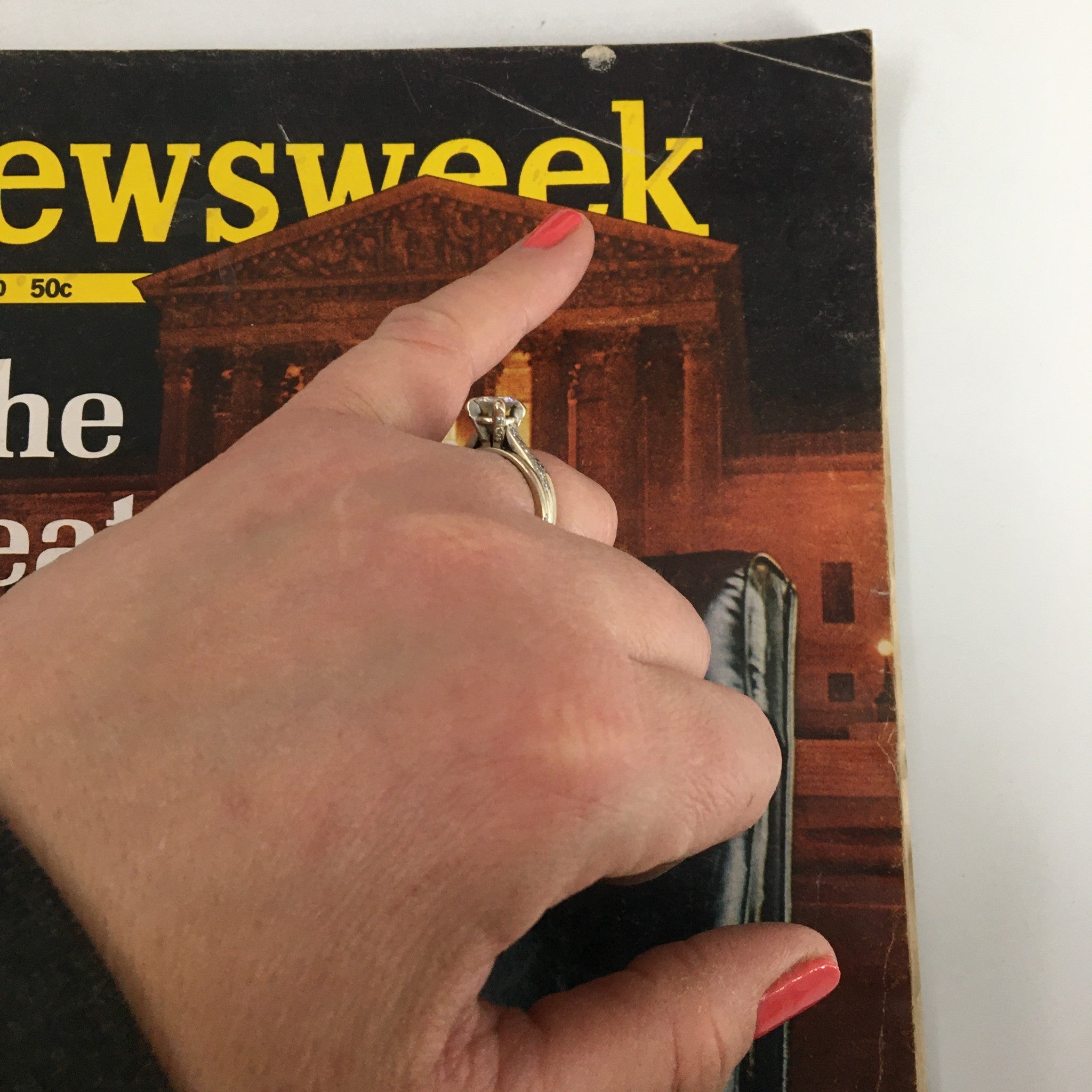 Hand pointing at the title on the cover of the vintage Newsweek magazine 'The Seat Nixon Can't Fill', April 20, 1970.