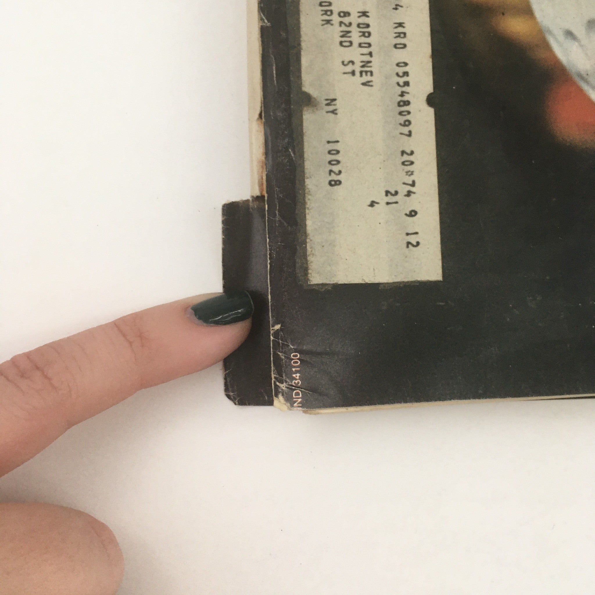 Close-up of the spine of New Times Magazine October 19 1973, featuring a vintage address label and worn edges, showcasing its collectible nature.