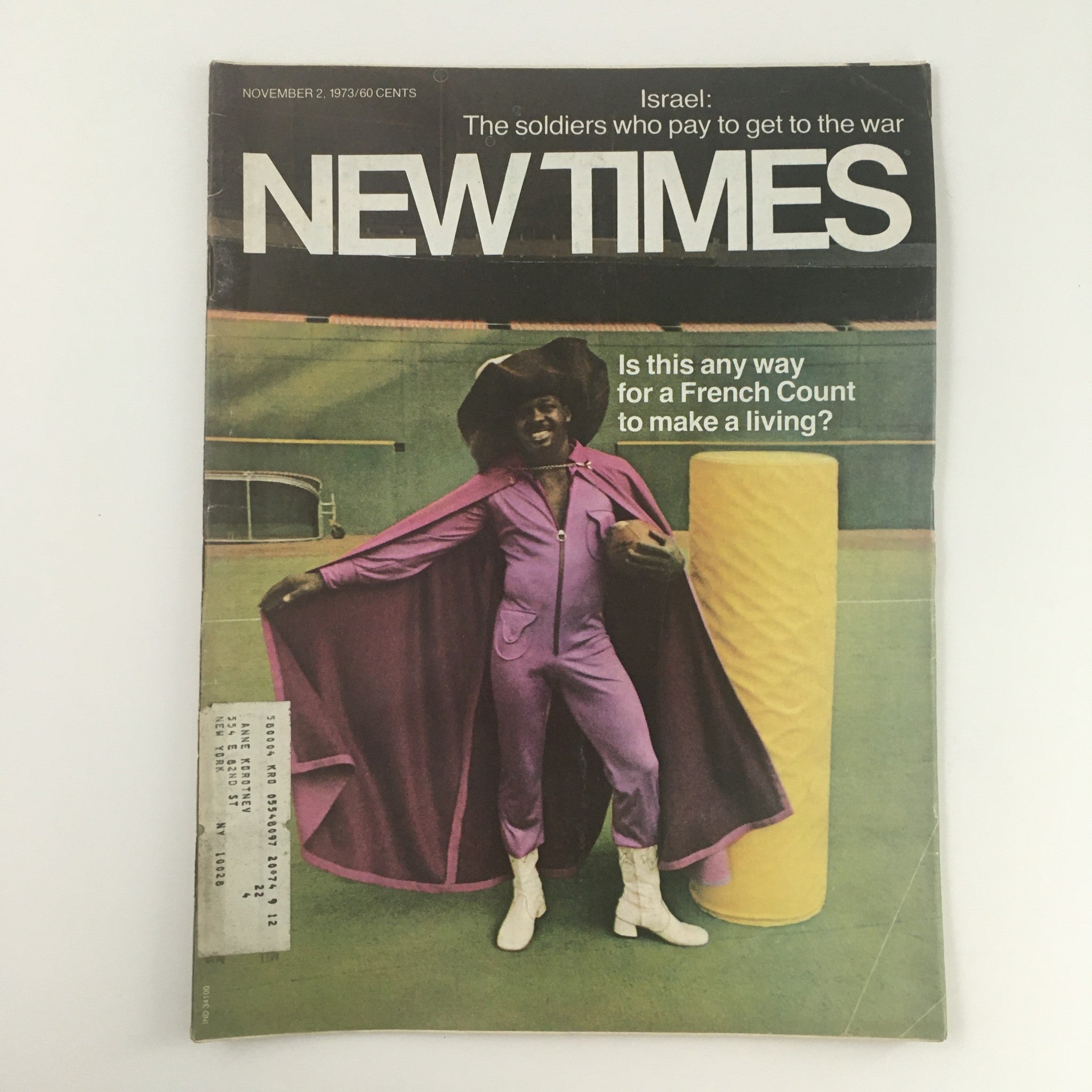 Cover of New Times Magazine from November 2, 1973, featuring the title 'Israel: The soldiers who pay to get to the war'. The cover showcases a man in a purple outfit and hat, striking a pose with a playful expression, highlighting a unique historical perspective on military service.