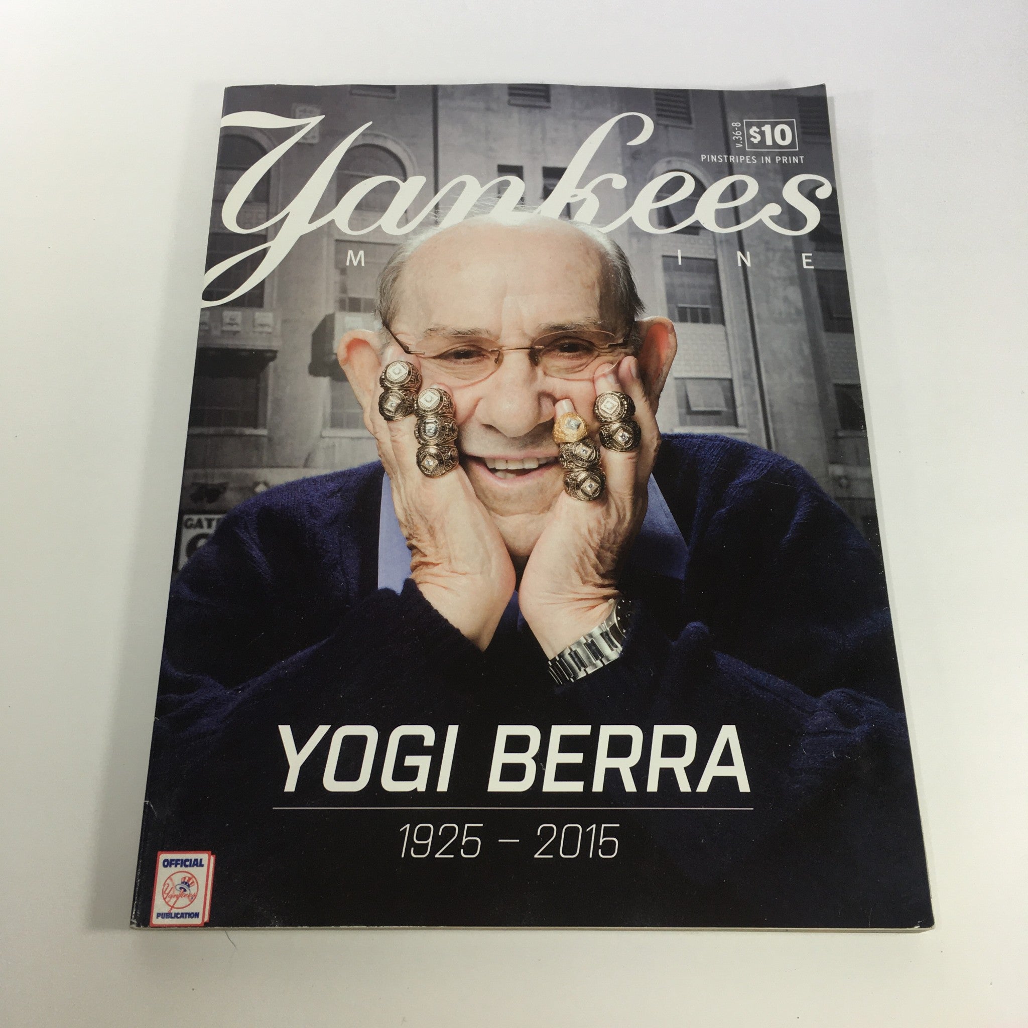 Cover of Yankees Magazine, October 2015 Volume #36-8, featuring Yogi Berra, celebrating his legacy from 1925 to 2015, showcasing his iconic image with championship rings and a heartfelt expression.