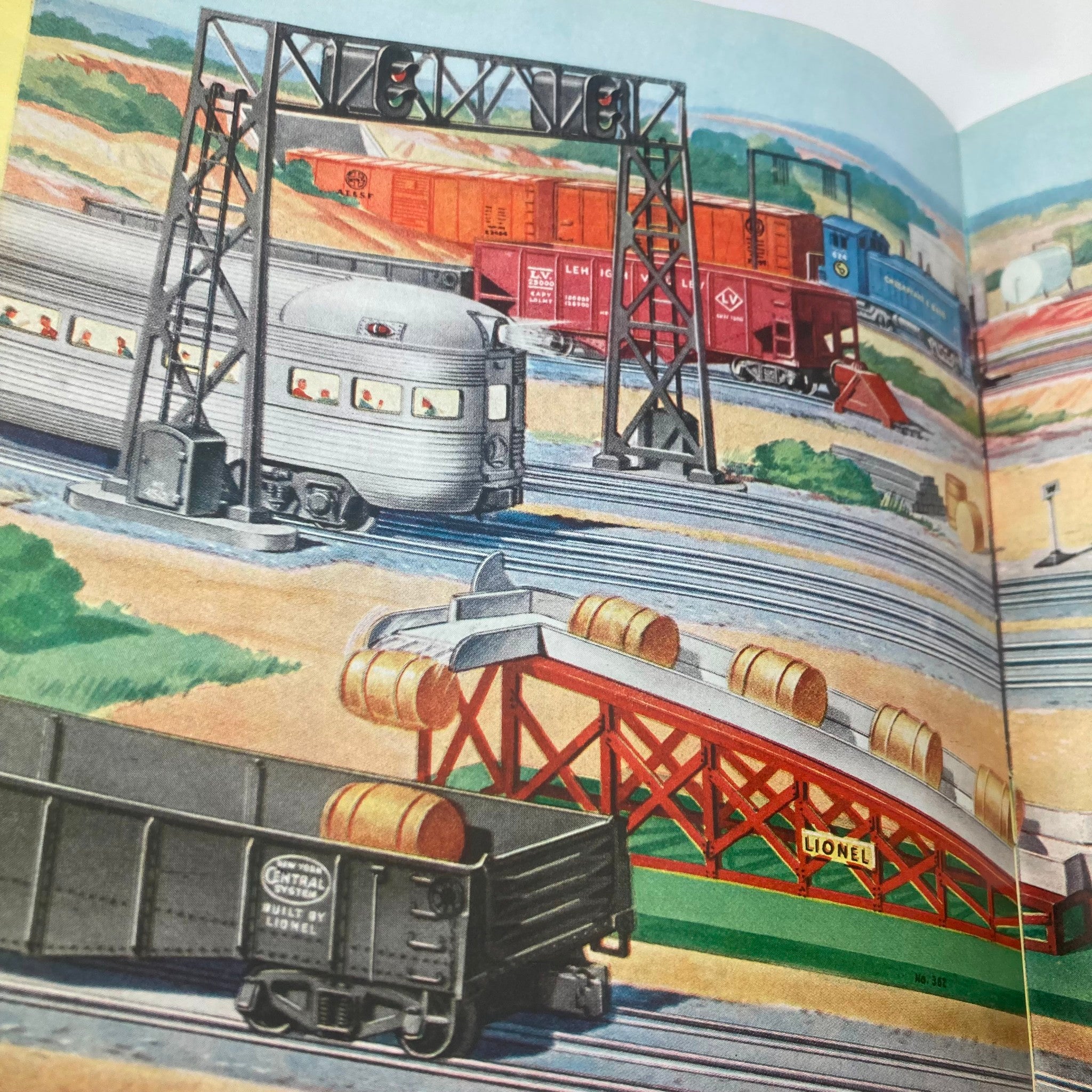 Detailed artwork from the 1952 Lionel Model Railroad Train Scout 3-Car Freight Catalog showing railway infrastructure, freight cars, and scenic landscapes.