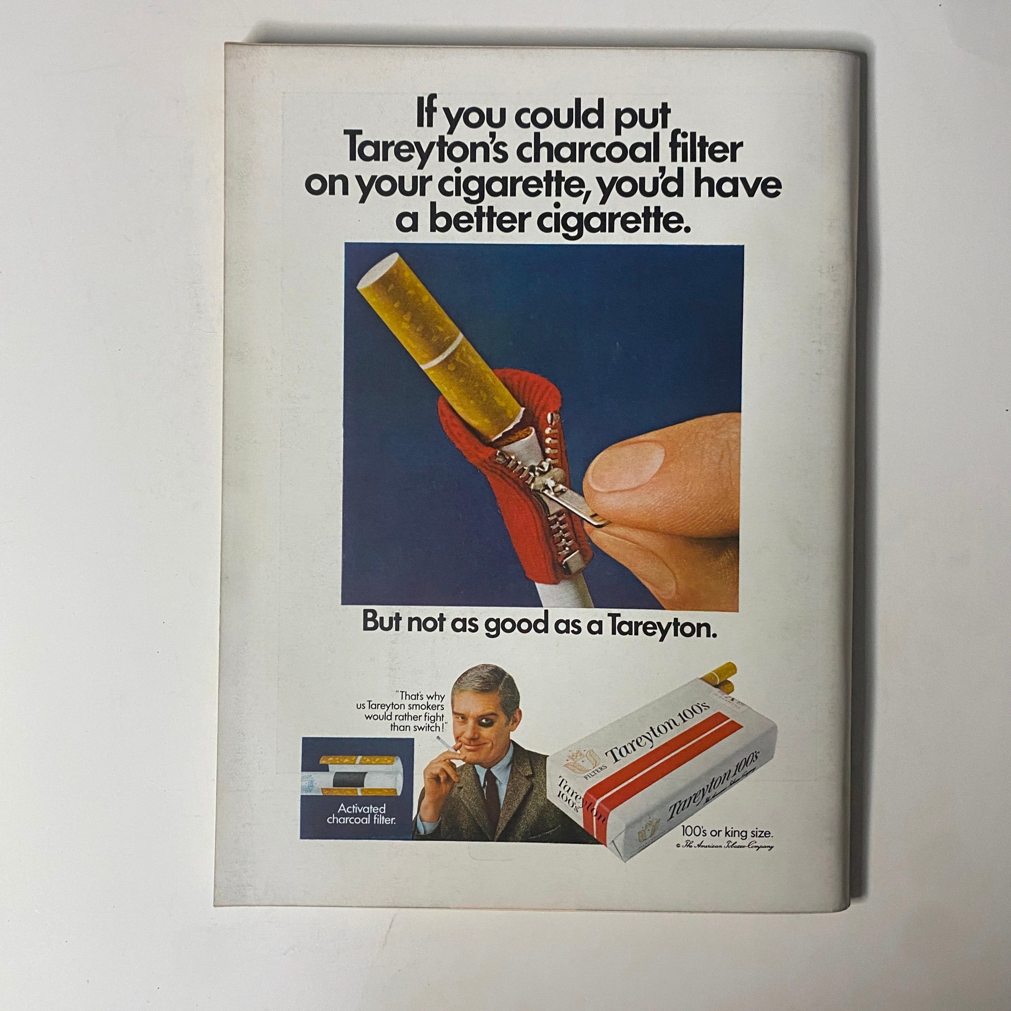 Advertisement from Playboy Magazine October 1968 featuring Tareyton cigarettes, showcasing a hand holding a cigarette with charcoal filter while promoting its quality. This ad reflects the advertising style of the late 1960s.