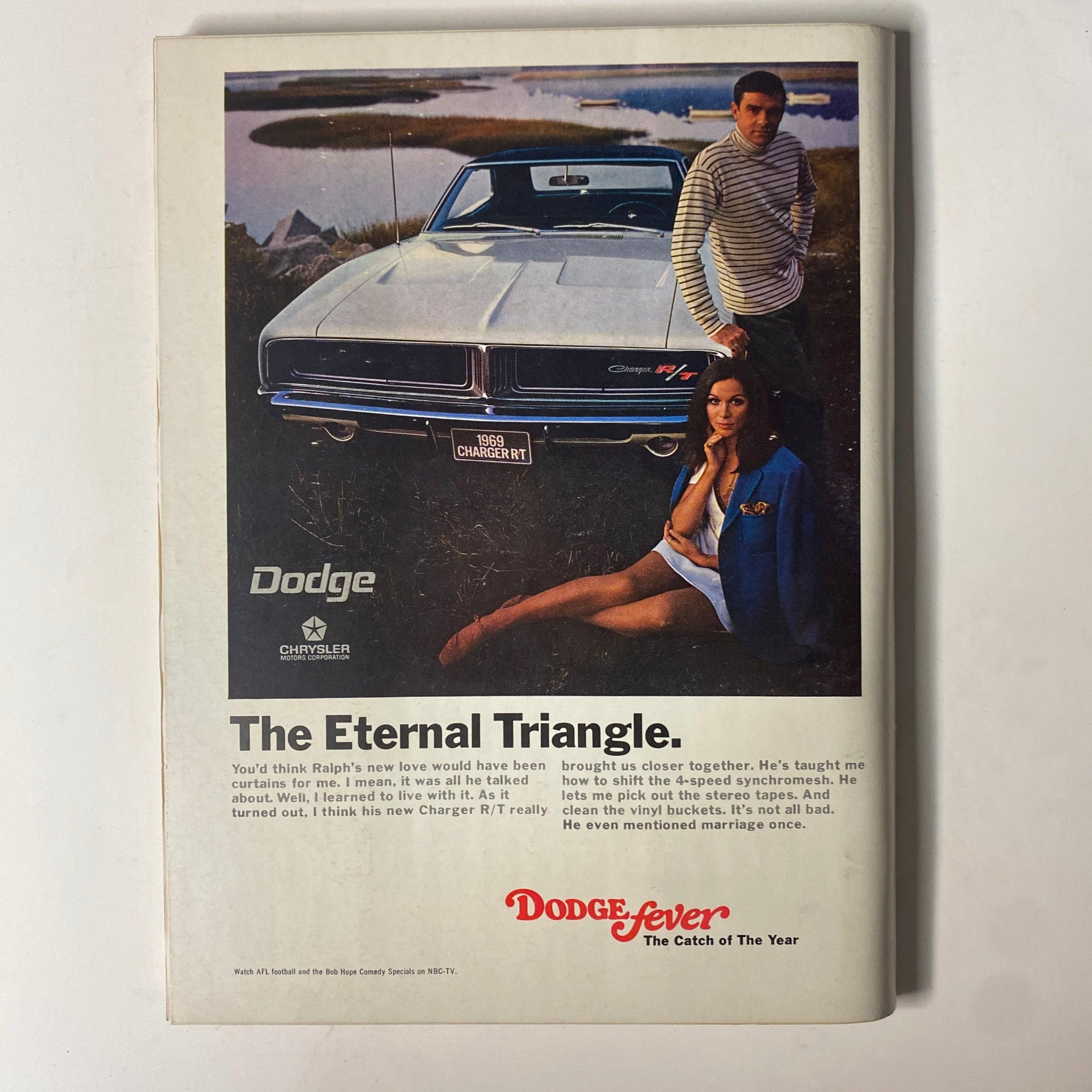 Back cover of Playboy Magazine December 1968 featuring a Dodge car advertisement with a couple by a lake.