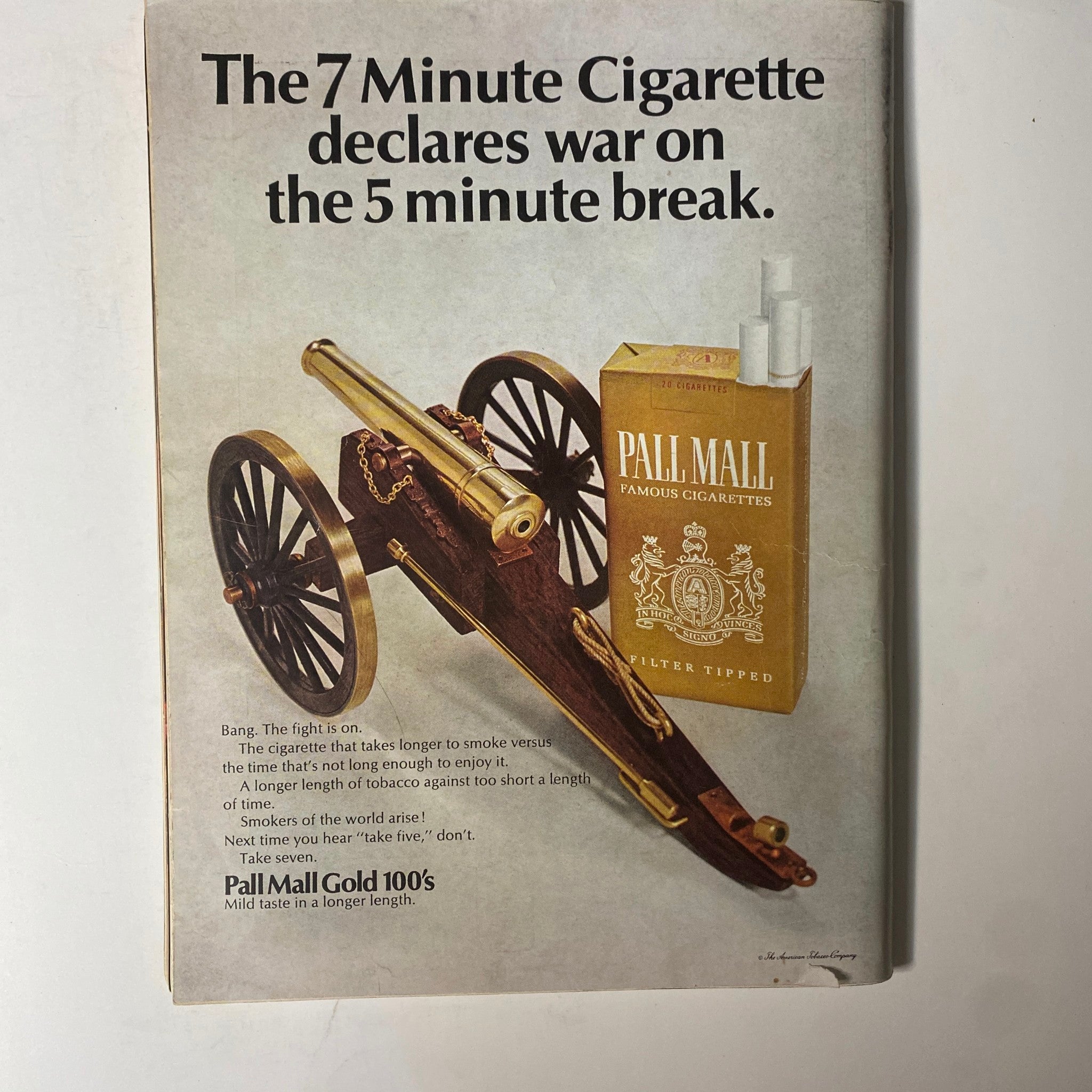 Advertisement from Playboy Magazine November 1967 for Pall Mall cigarettes, featuring a creative layout with a cannon and a cigarette pack, capturing the unique advertising style of the era.