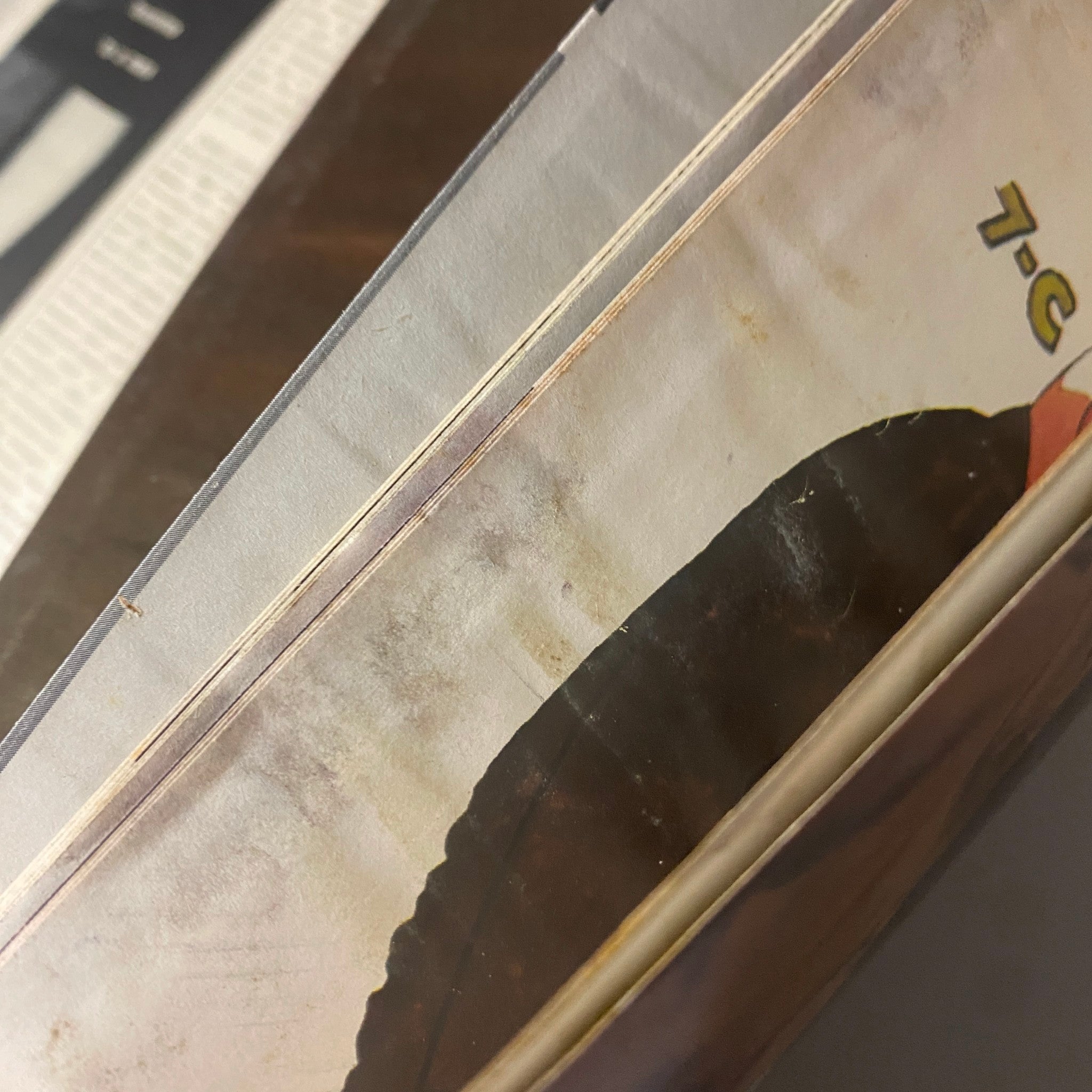 Close-up view of the binding of Playboy Magazine September 1957 showing signs of wear, preserving the centerfold featuring Jacquelyn Prescott.