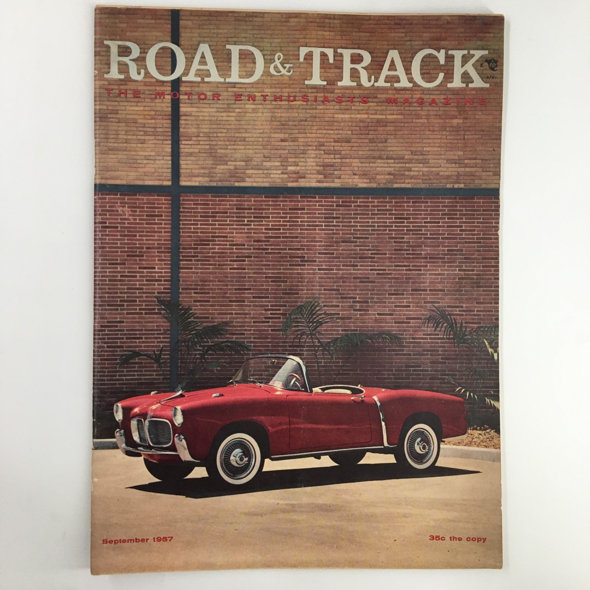VTG Road & Track Magazine September 1957 cover showcasing a classic red convertible car against a brick background.