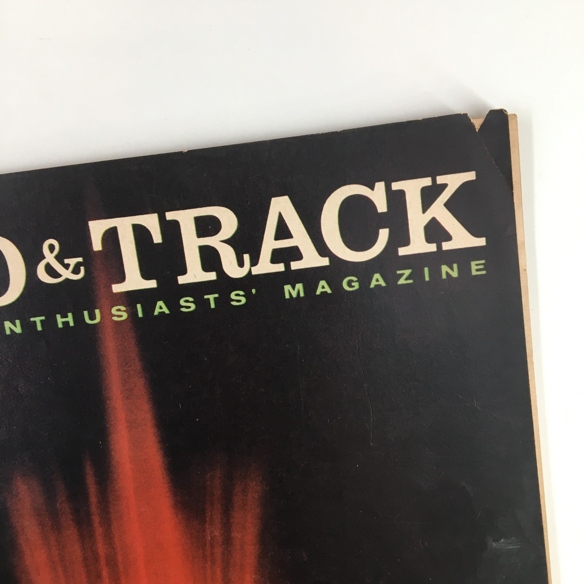 Close-up of the title from VTG Road & Track Magazine May 1958 showcasing The Gigantic Rolls-Royce P-II with a vibrant fountain backdrop.
