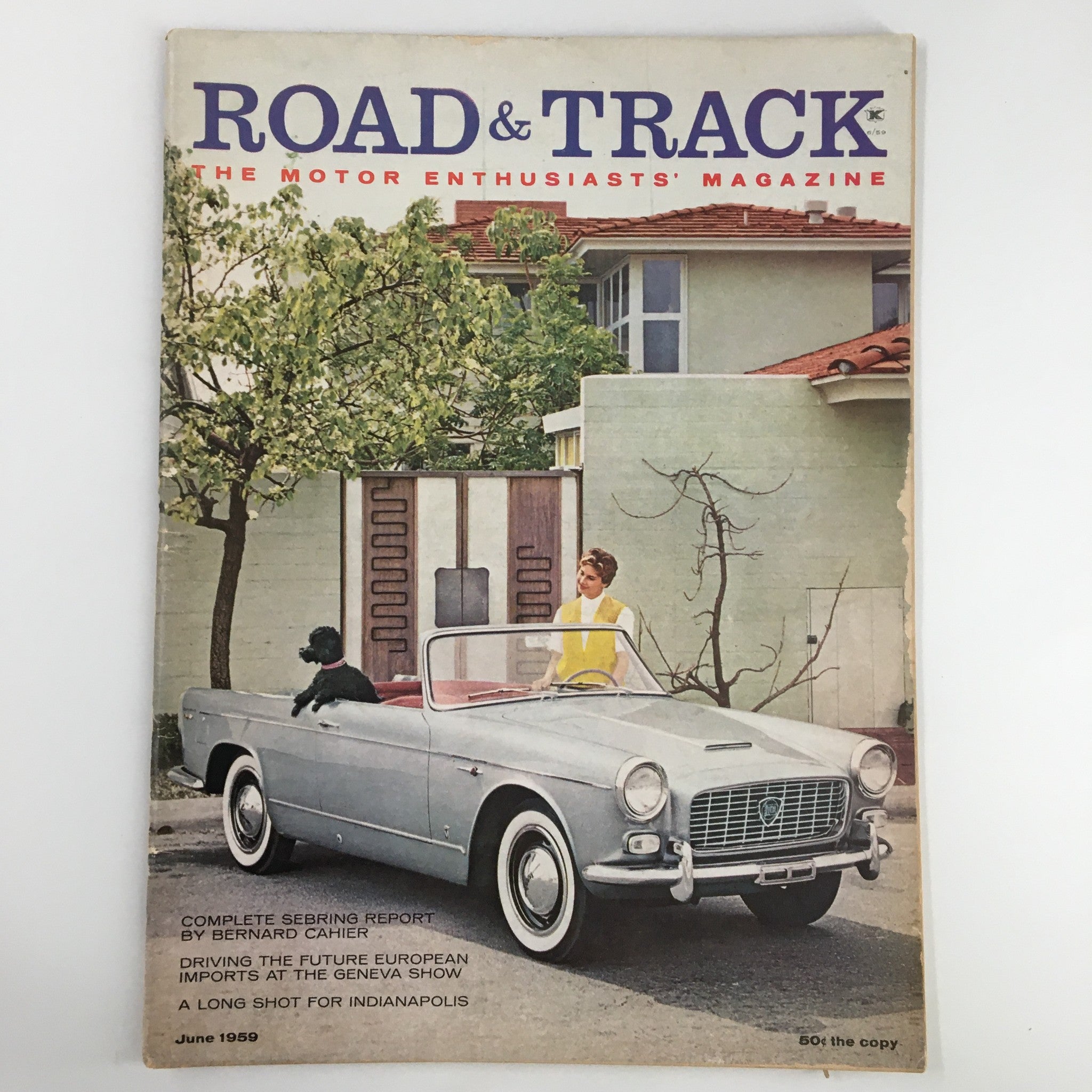 Cover of VTG Road & Track Magazine June 1959 featuring a vintage convertible car and a woman in a yellow top, highlighting the article 'A Long Shot for Indianapolis'.