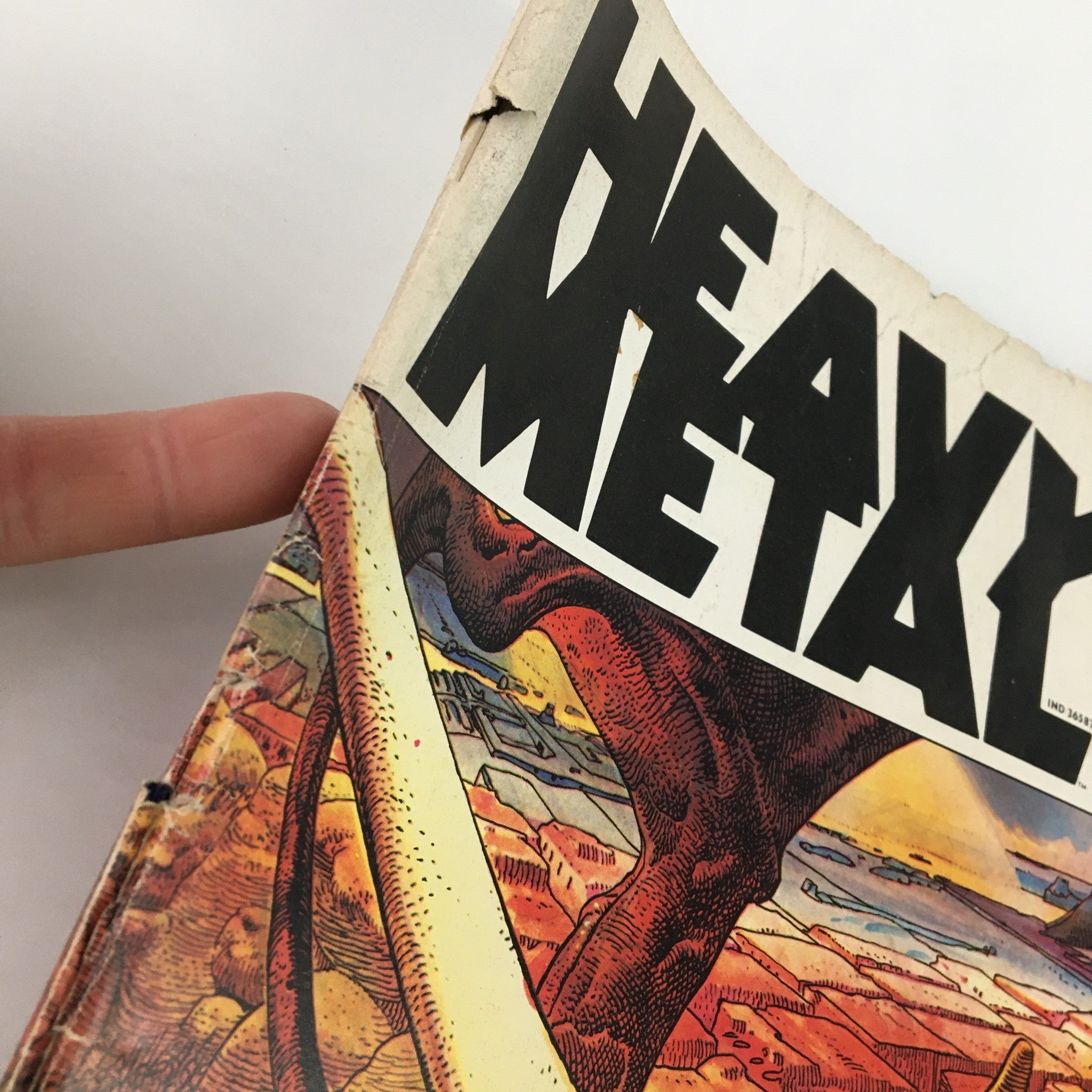 Close-up view of 'Heavy Metal Magazine' July 1977, Vol I #4 cover, featuring artistic illustrations and the title prominently displayed, highlighting the vintage aesthetic of the magazine featuring 'Arzach Rides Again'.