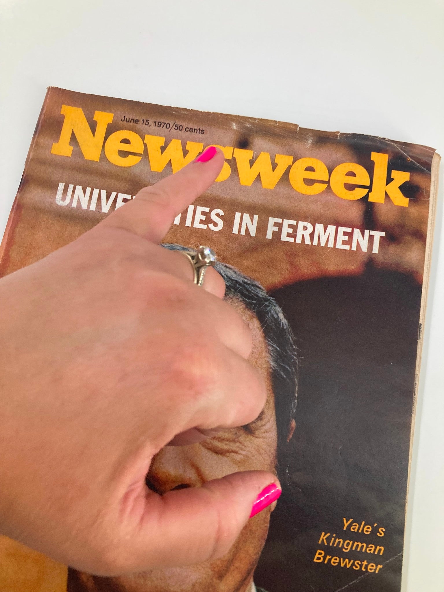 Close-up of a hand pointing at the title of the VTG Newsweek Magazine June 15 1970, which features Yale University's Kingman Brewster on the cover.