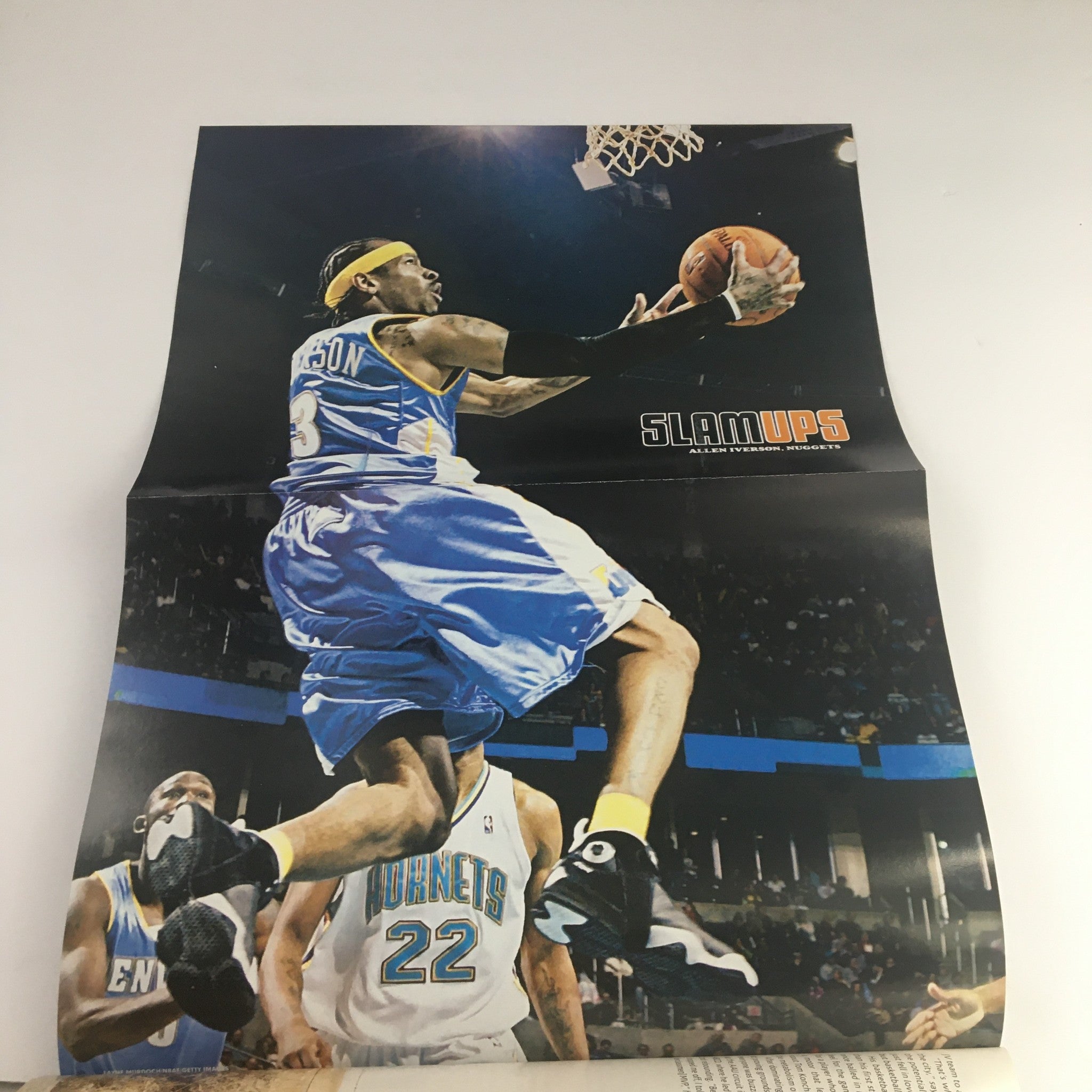 Poster from Slam Magazine April 2007 showcasing Allen Iverson performing a slam dunk for the Denver Nuggets, capturing the excitement of NBA basketball.