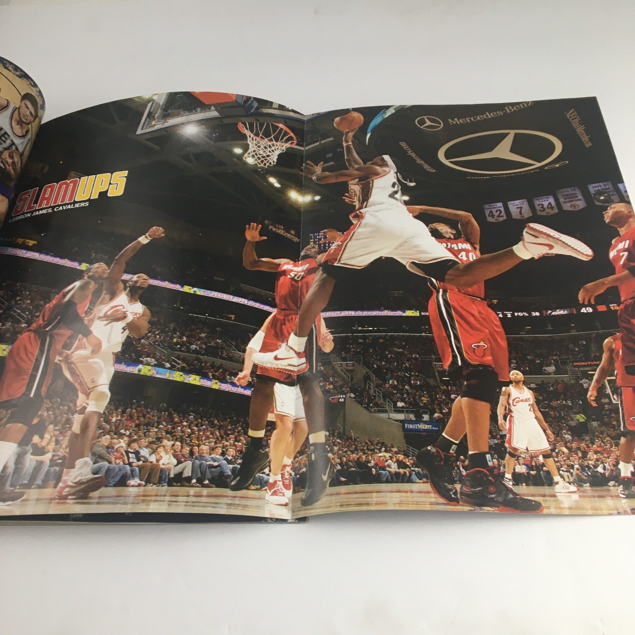 Inside spread of Slam Magazine April 2009 displaying a dynamic basketball play with players from the Cleveland Cavaliers during a game, emphasizing the excitement of basketball action.