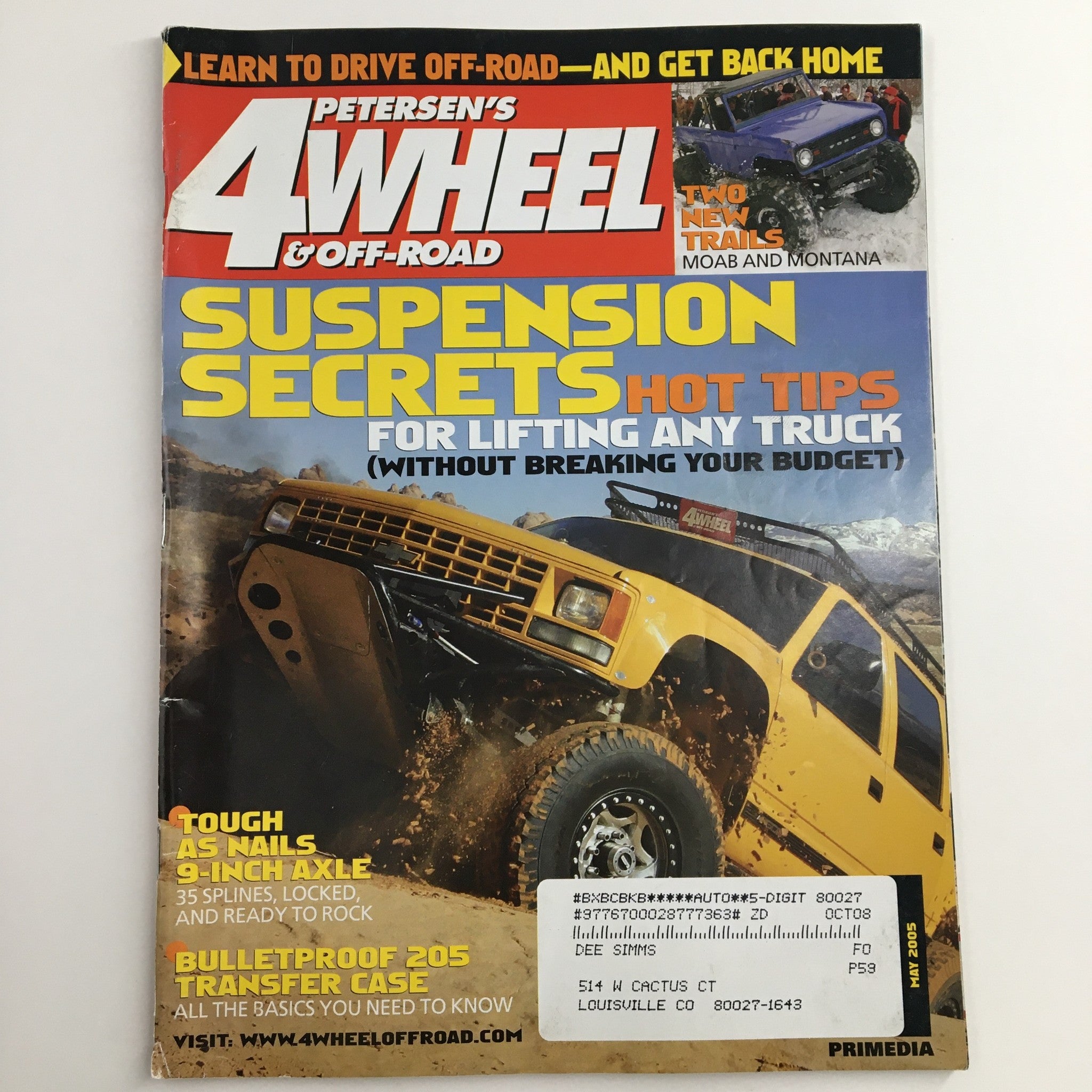 Cover of Petersen's 4 Wheel & Off-Road Magazine May 2005, featuring 'Suspension Secrets & Hot Tips' for lifting trucks. The image showcases an off-road vehicle in action, highlighting essential tips for enhancing vehicle suspension.