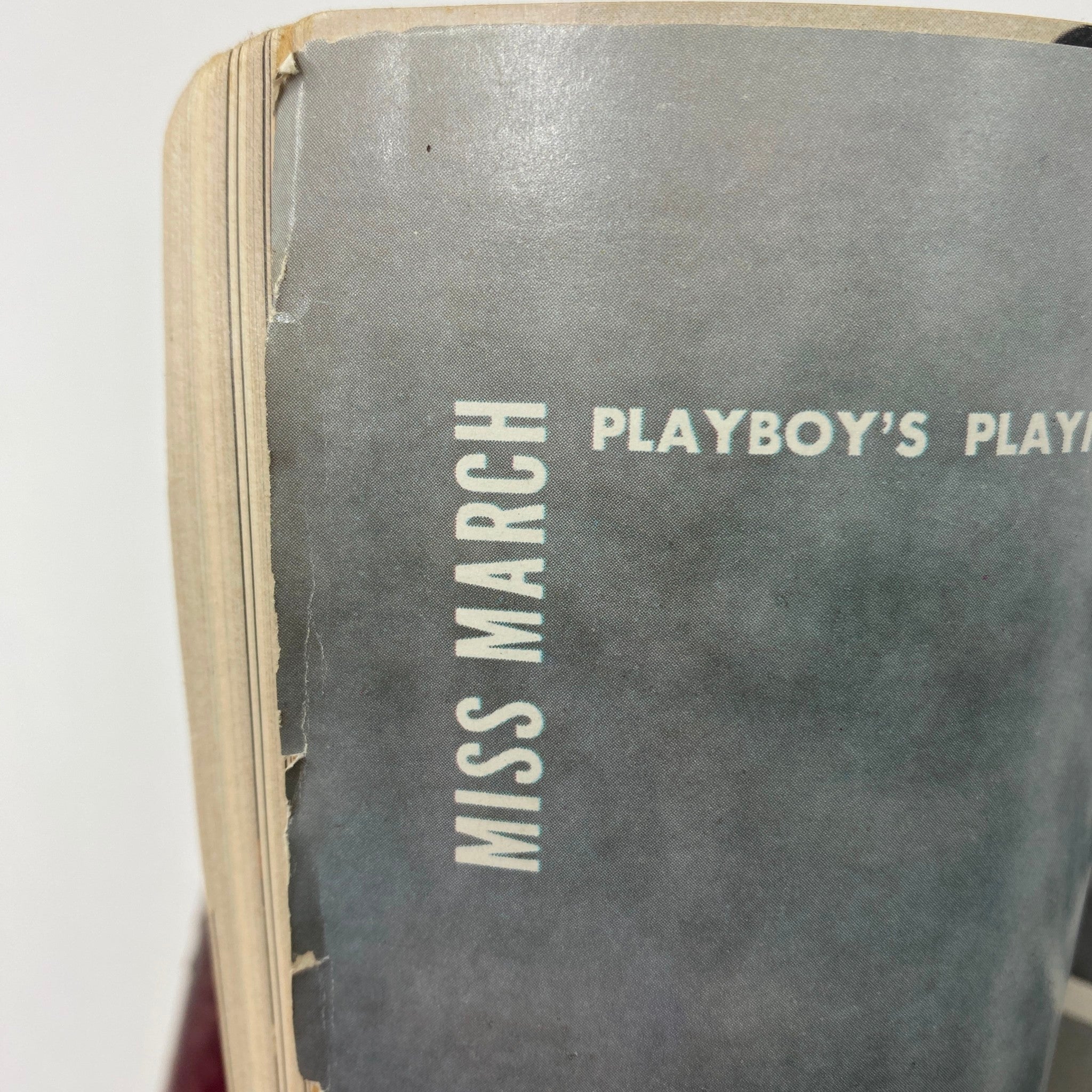 Detailed view of the spine of a VTG Playboy Magazine from March 1972, showcasing the edition's title 'Miss March' and its vintage aesthetic.