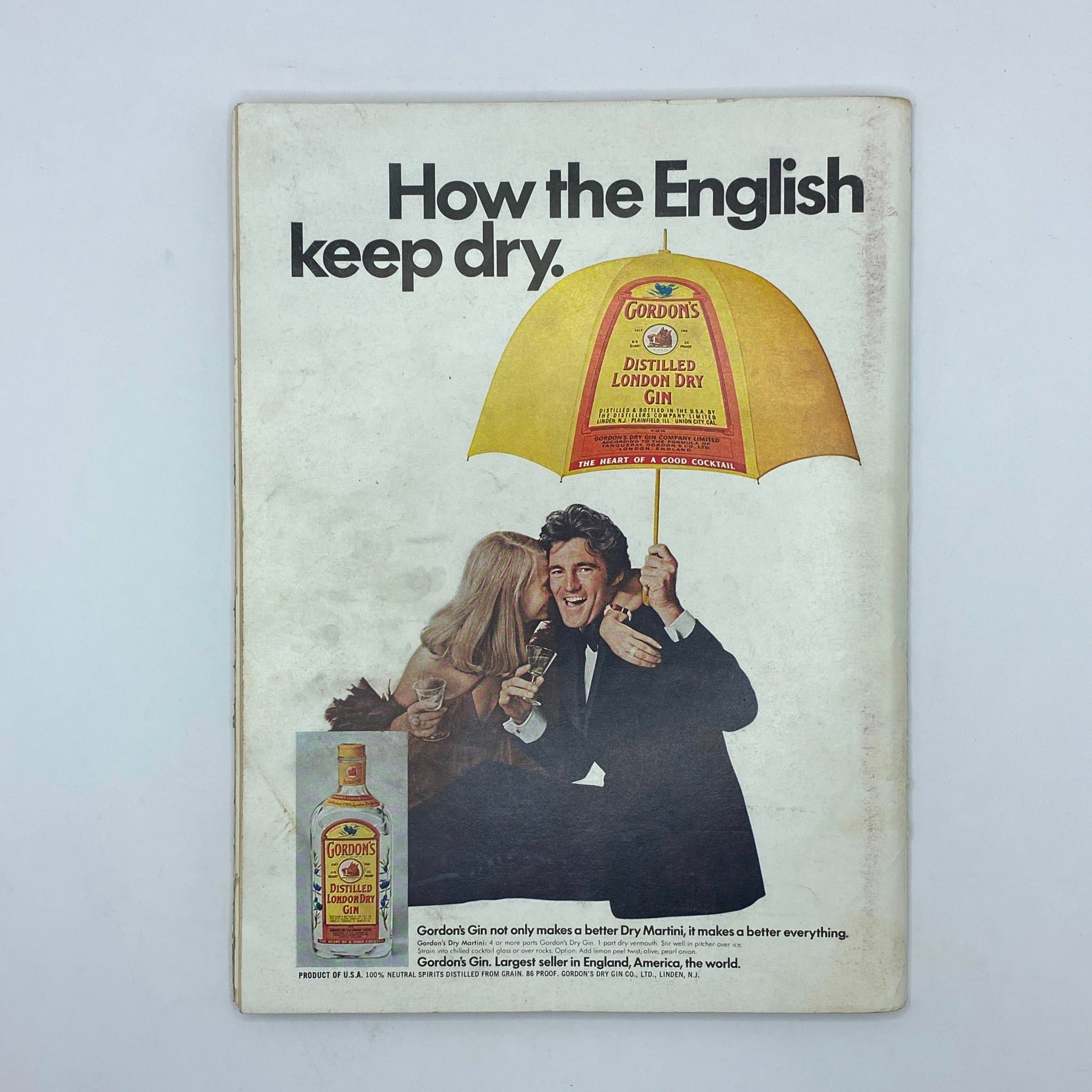 Back cover of the VTG Playboy Magazine May 1974 showcasing an advertisement for Gordon's London Dry Gin with a couple under an umbrella.