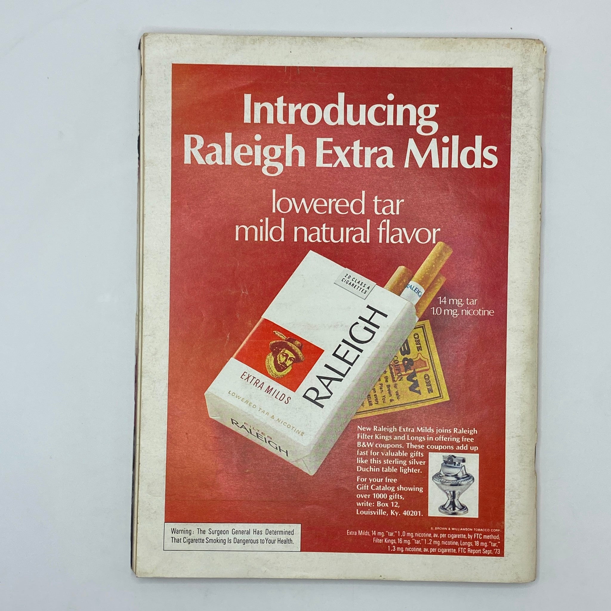 Cover of VTG Playboy Magazine March 1974 featuring Debbie Shelton as the centerfold, showcasing an advertisement for Raleigh Extra Mids cigarettes highlighting lower tar and mild natural flavor.