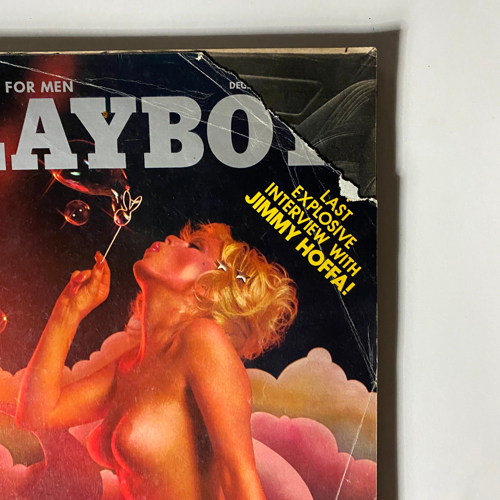 Close-up of Playboy Magazine December 1975 cover highlighting the last interview with Jimmy Hoffa, featuring Nancie Li Brand in a striking pose amidst colorful background.