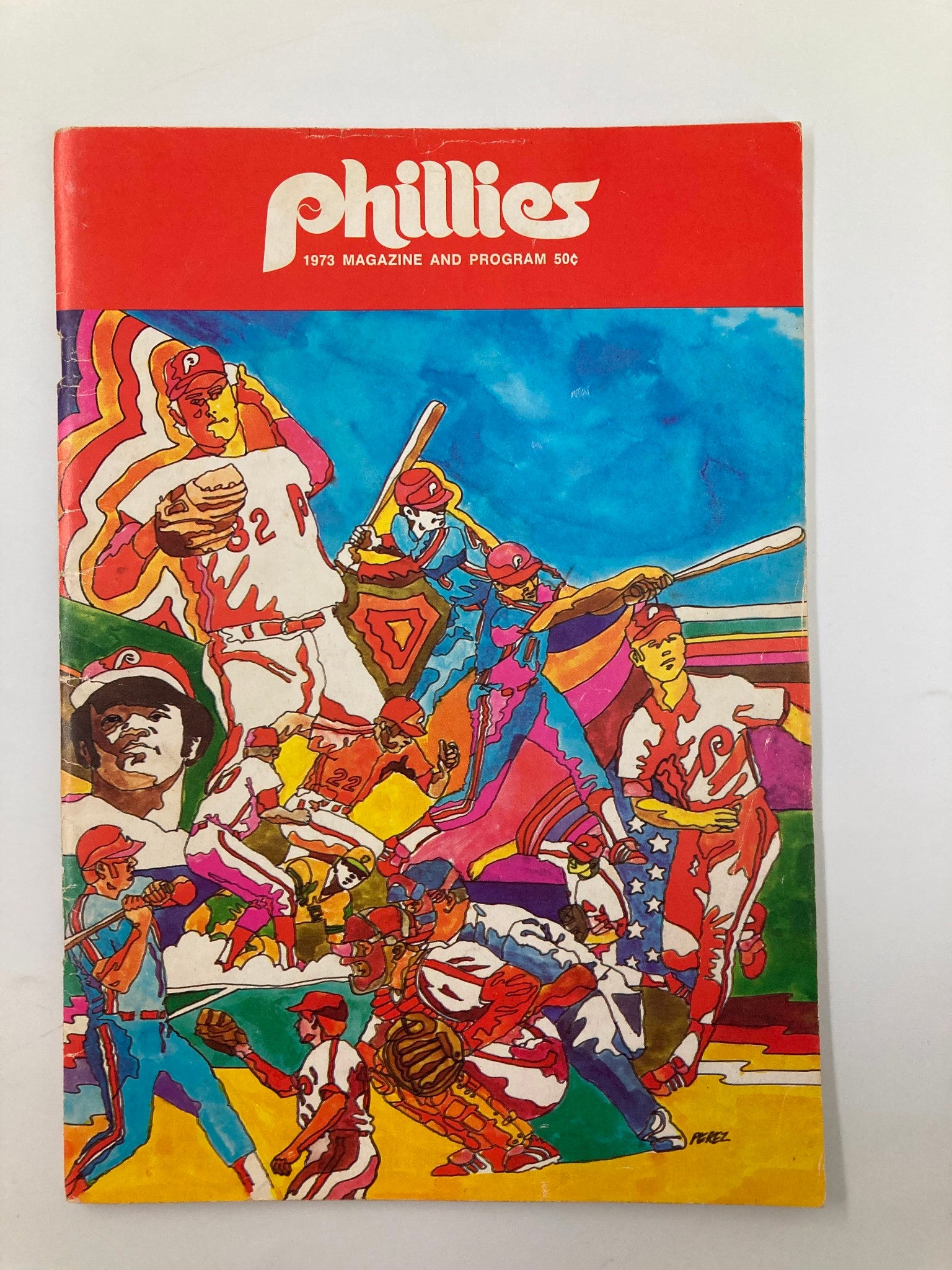 Cover of the 1973 MLB Philadelphia Phillies Magazine featuring vibrant artwork depicting players and baseball themes.